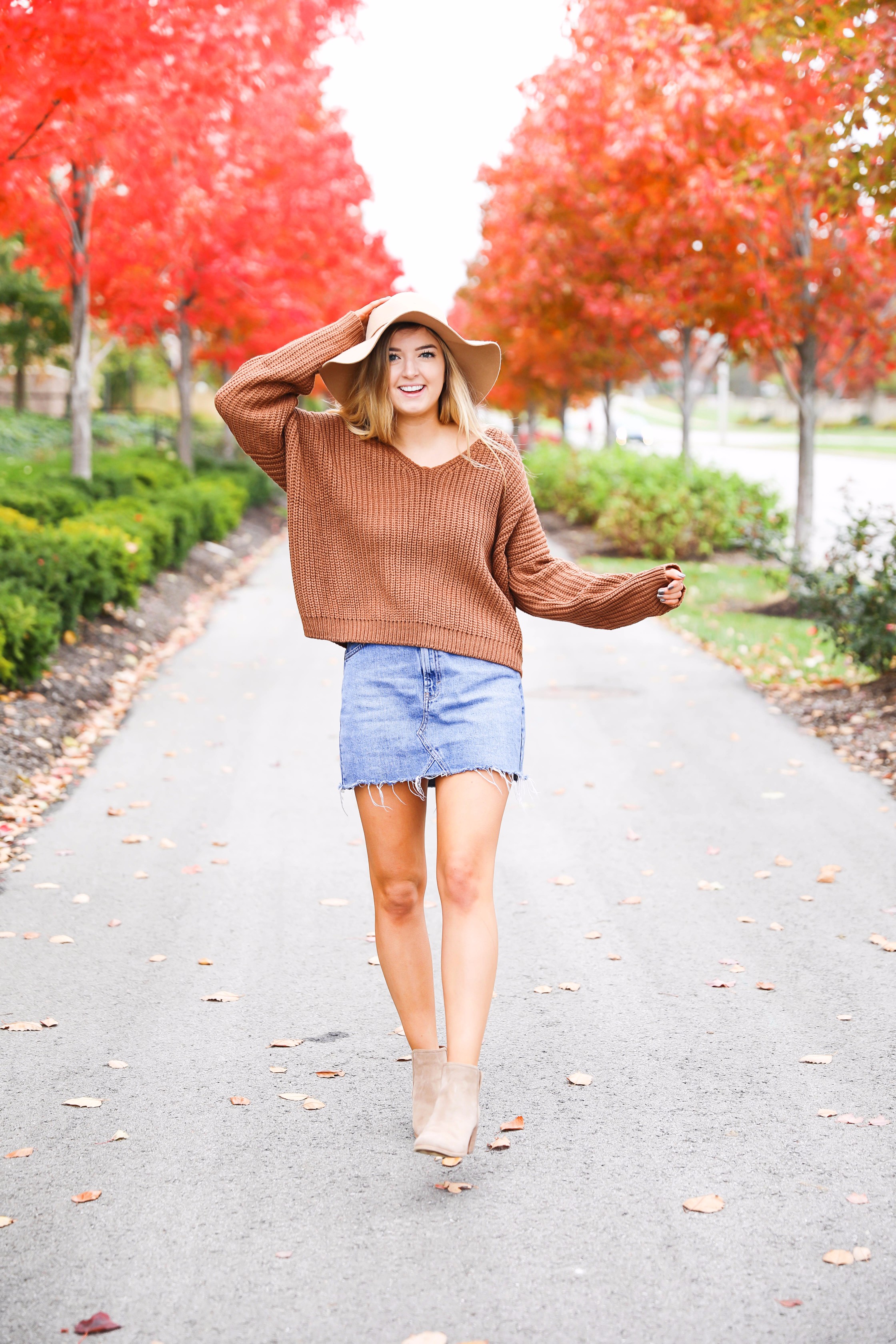 Burnt orange sweater that is crisscrossed tied in the back! Perfect for fall paired with jeanskirt and floppy felt hat. Fall and thanksgiving outfit ideas! Details on fashion blog daily dose of charm by lauren lindmark