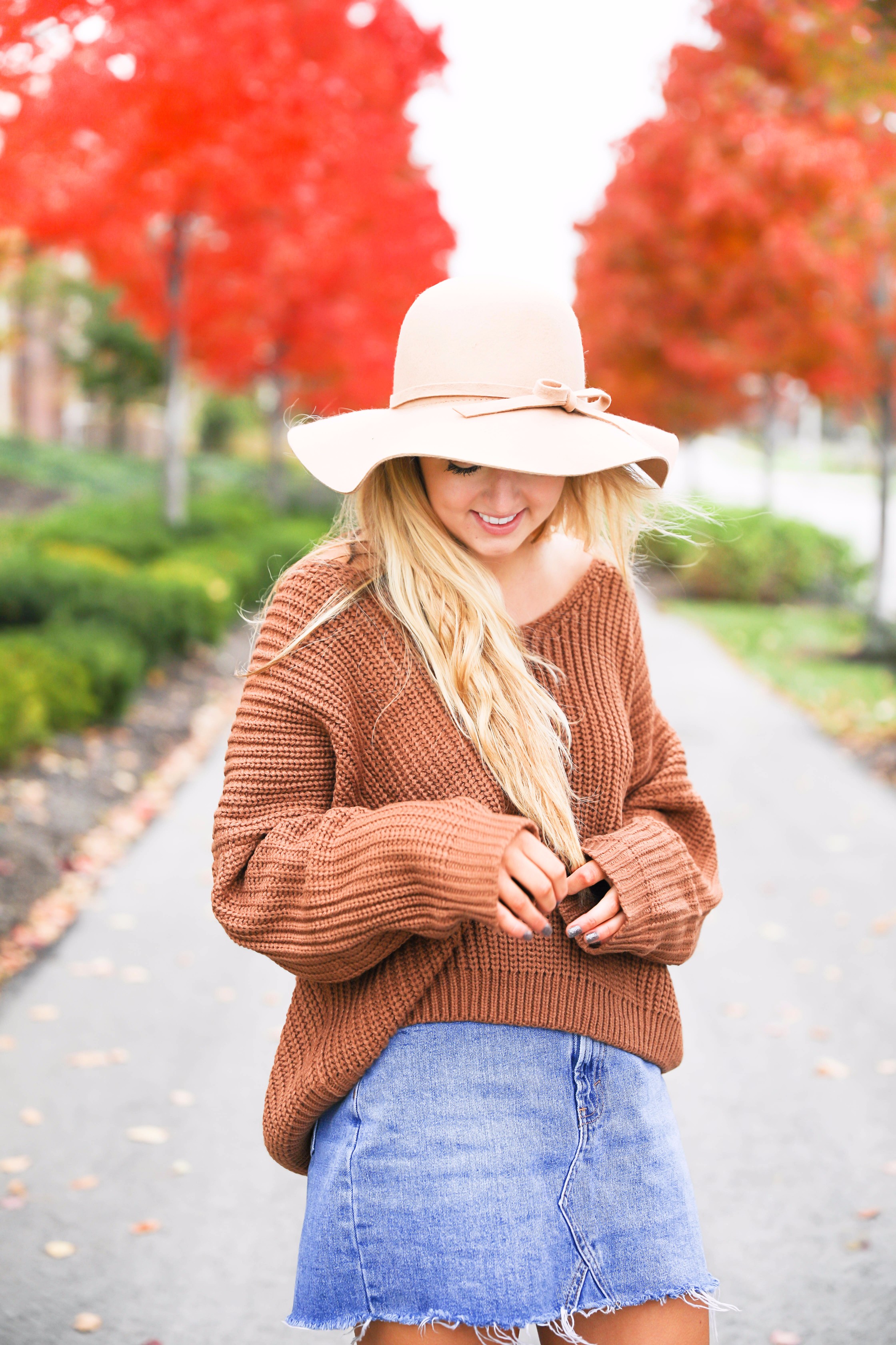 Burnt orange sweater that is crisscrossed tied in the back! Perfect for fall paired with jeanskirt and floppy felt hat. Fall and thanksgiving outfit ideas! Details on fashion blog daily dose of charm by lauren lindmark