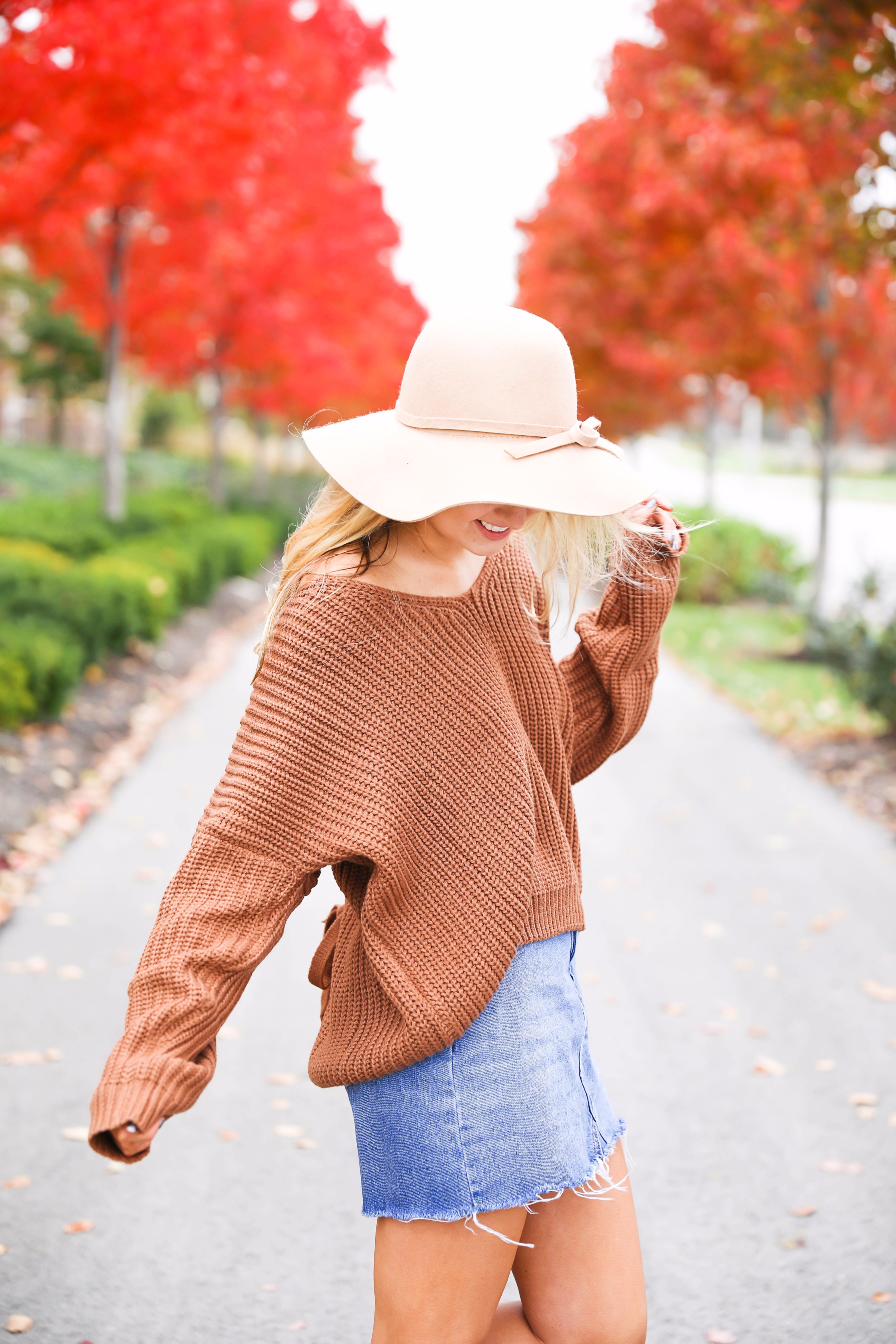 Burnt orange sweater that is crisscrossed tied in the back! Perfect for fall paired with jeanskirt and floppy felt hat. Fall and thanksgiving outfit ideas! Details on fashion blog daily dose of charm by lauren lindmark