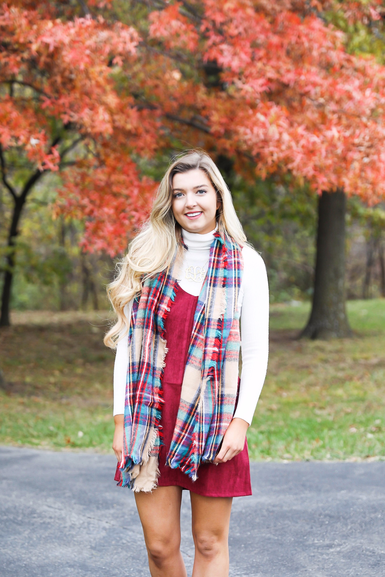 Red corduroy overall dress with white turtleneck and blanket scarf! The cutest fall outfit for a fall trees and foliage photoshoot! Get details on fashion blog daily dose of charm lauren lindmark