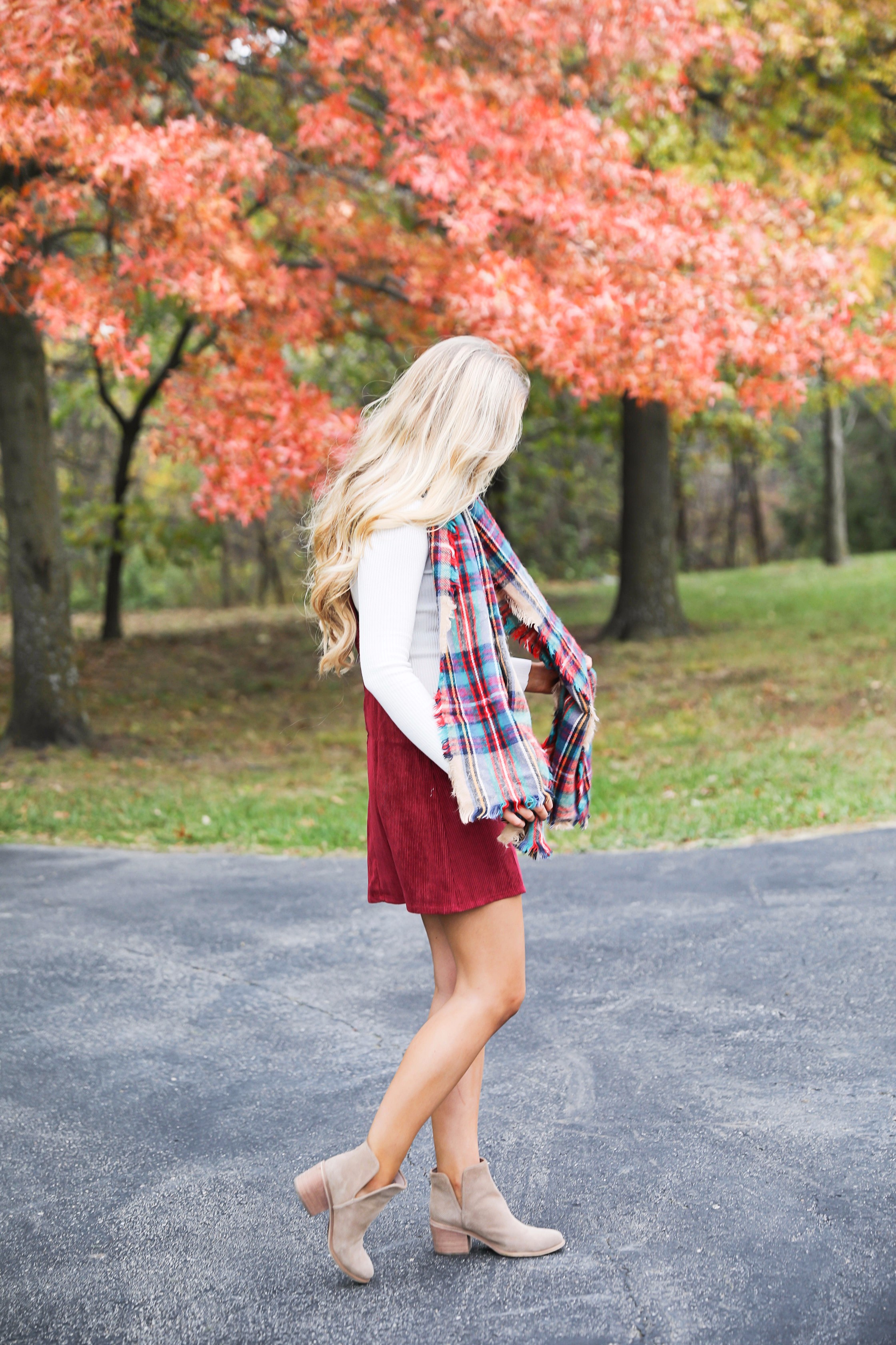 Red corduroy overall dress with white turtleneck and blanket scarf! The cutest fall outfit for a fall trees and foliage photoshoot! Get details on fashion blog daily dose of charm lauren lindmark