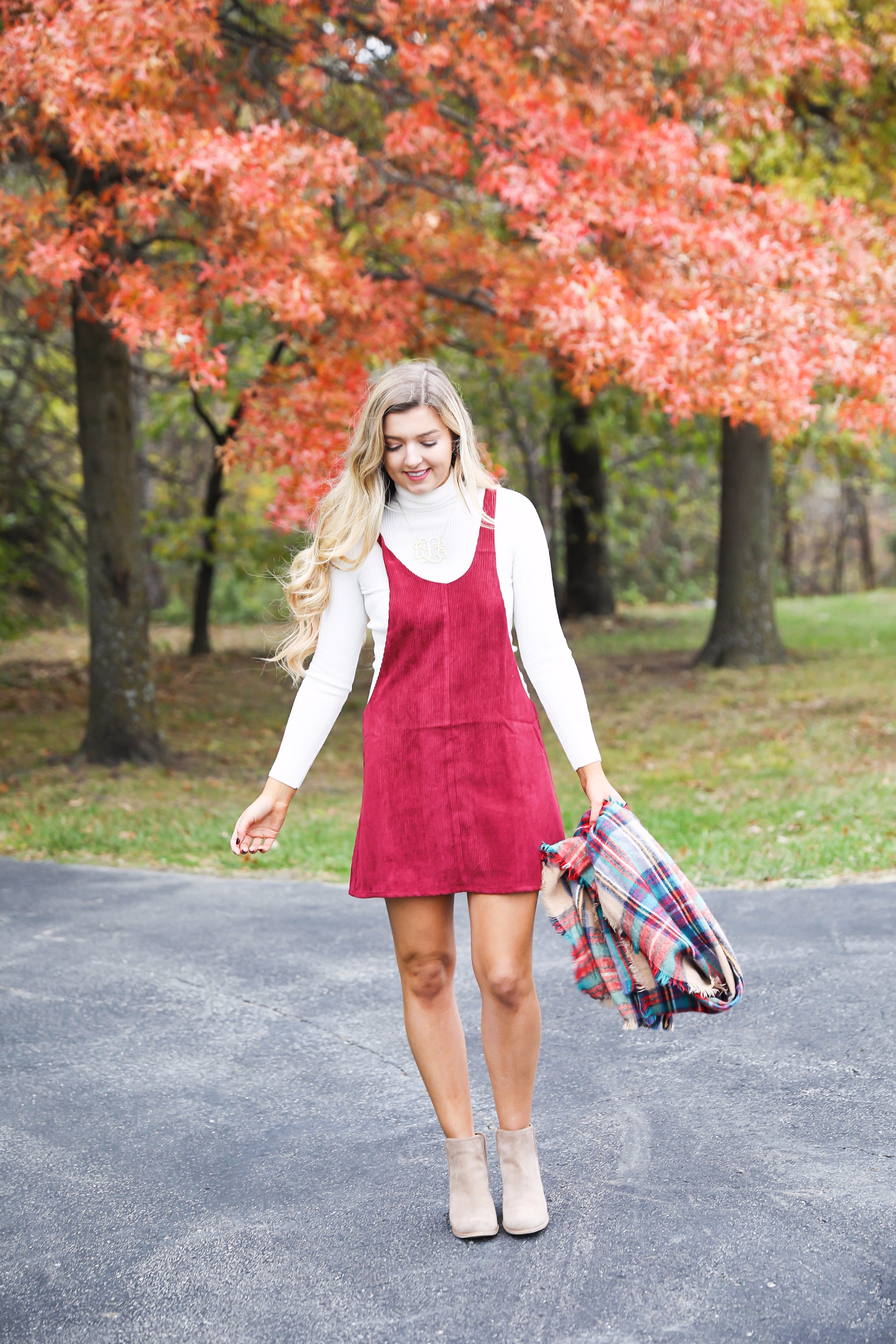 Red corduroy overall dress with white turtleneck and blanket scarf! The cutest fall outfit for a fall trees and foliage photoshoot! Get details on fashion blog daily dose of charm lauren lindmark