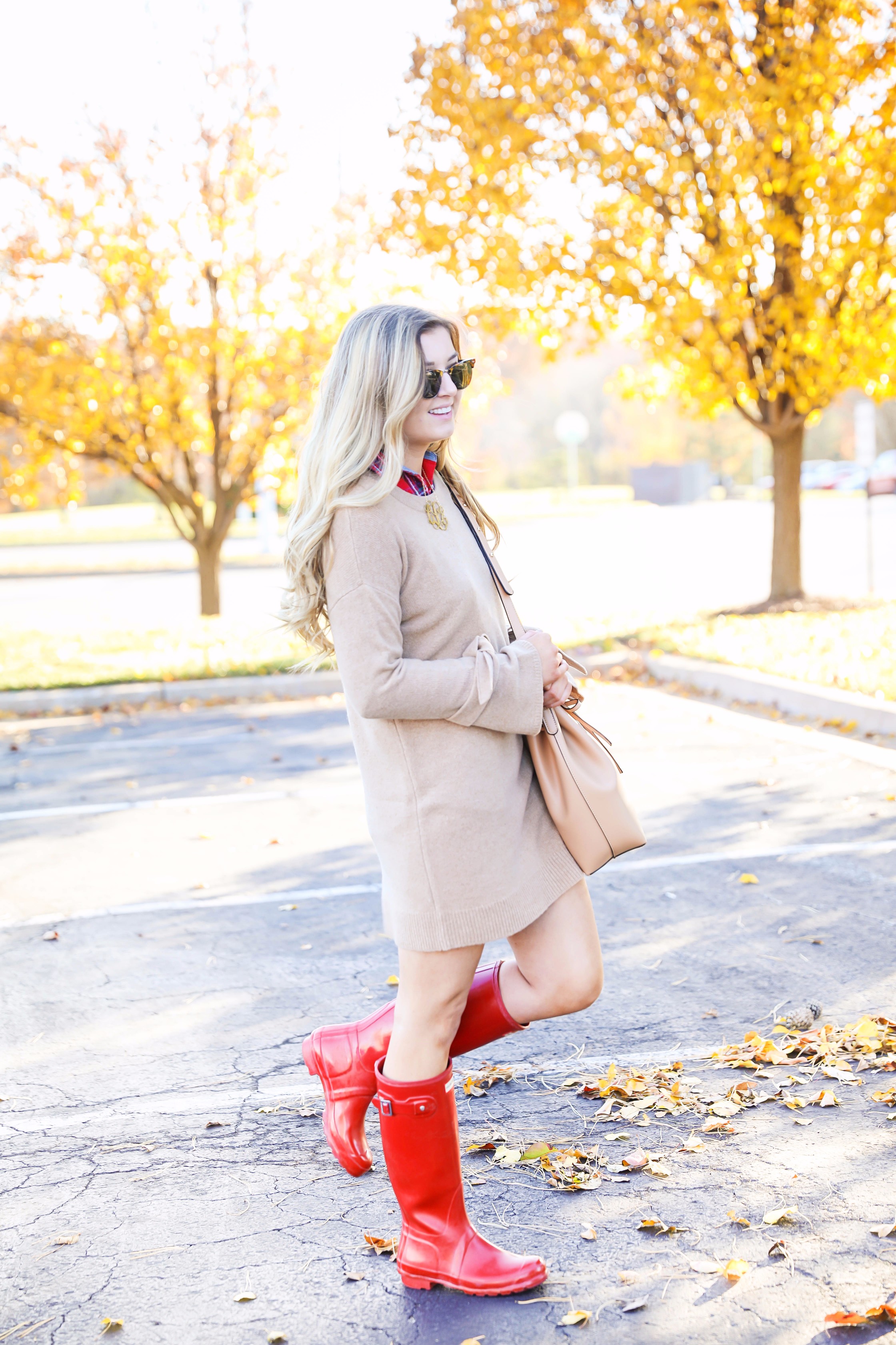 Thanksgiving outfit idea tan dress with tied sleeves! Layered with flannel underneath! I love this fall outfit with hunter boots! Details on fashion blog daily dose of charm by lauren lindmark