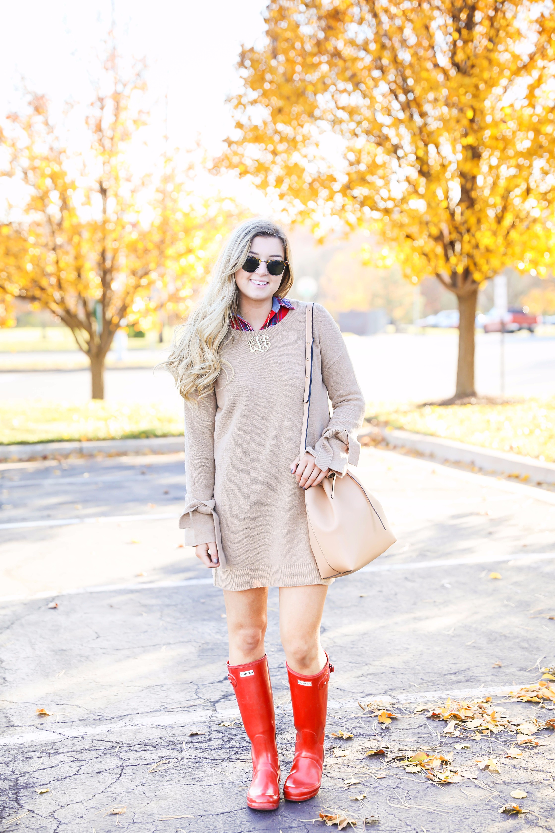 Thanksgiving outfit idea tan dress with tied sleeves! Layered with flannel underneath! I love this fall outfit with hunter boots! Details on fashion blog daily dose of charm by lauren lindmark