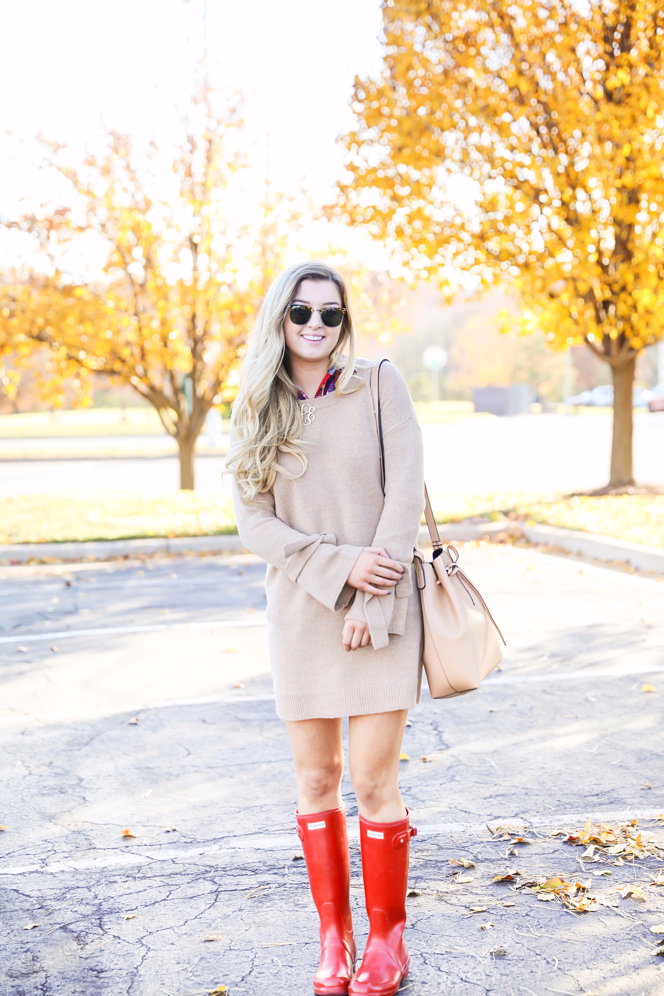 Thanksgiving outfit idea tan dress with tied sleeves! Layered with flannel underneath! I love this fall outfit with hunter boots! Details on fashion blog daily dose of charm by lauren lindmark