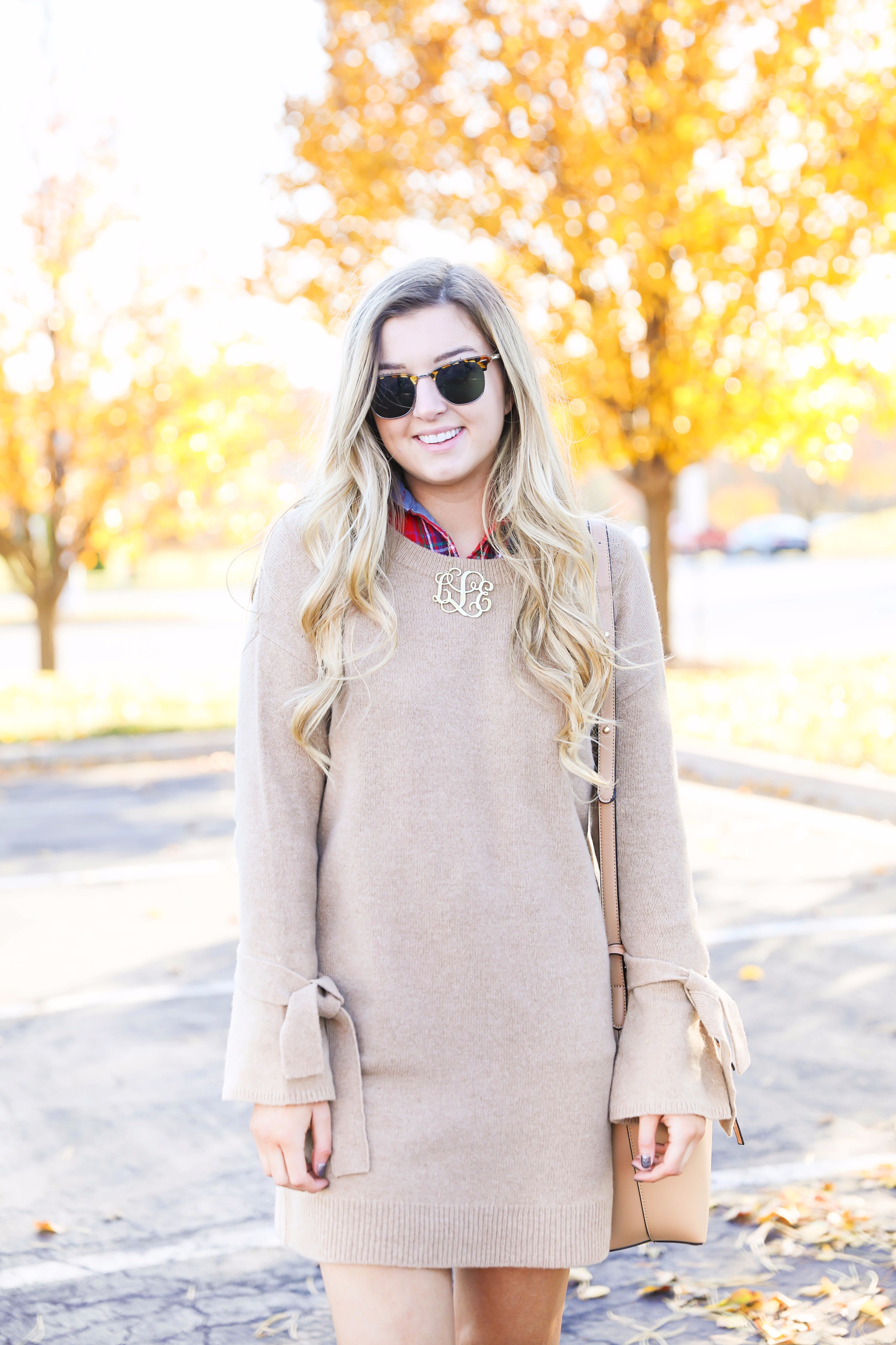 Thanksgiving outfit idea tan dress with tied sleeves! Layered with flannel underneath! I love this fall outfit with hunter boots! Details on fashion blog daily dose of charm by lauren lindmark