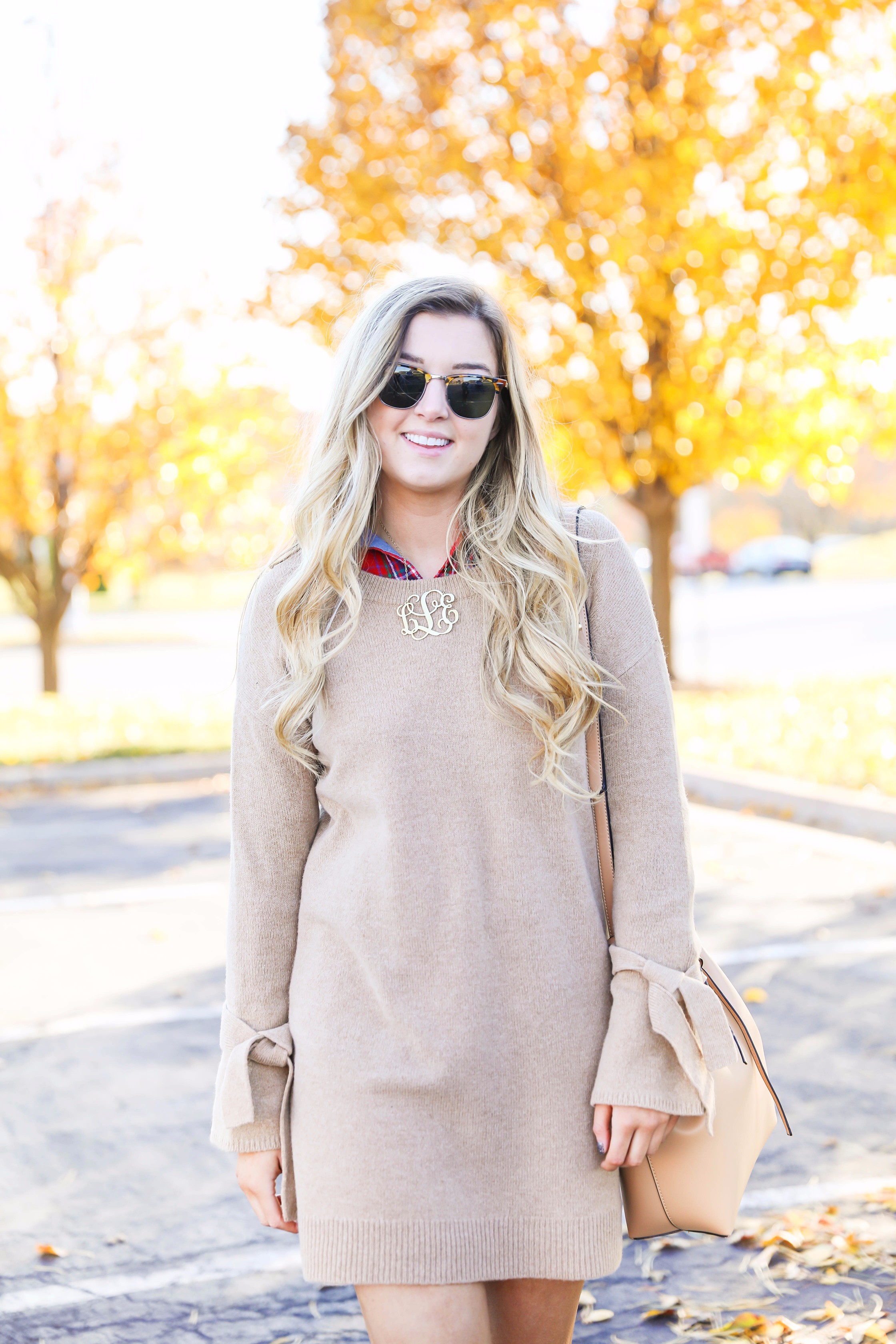 Thanksgiving outfit idea tan dress with tied sleeves! Layered with flannel underneath! I love this fall outfit with hunter boots! Details on fashion blog daily dose of charm by lauren lindmark