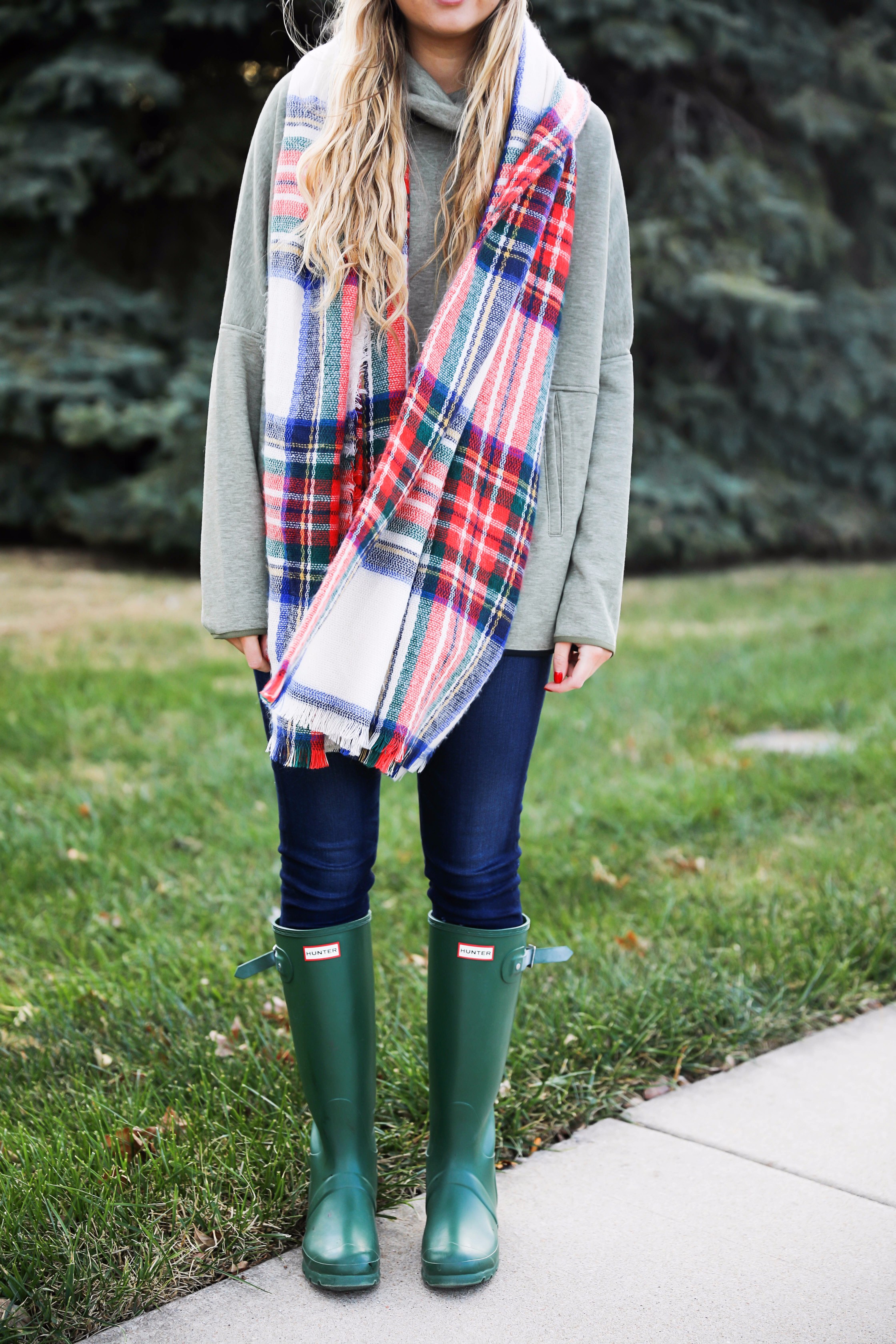 Christmas colored plaid scarf paired with my olive north face and faux fur ear beanie! Wearing my green hunter boots to make this look a casual holiday outfit! Details on daily dose of charm by lauren lindmark