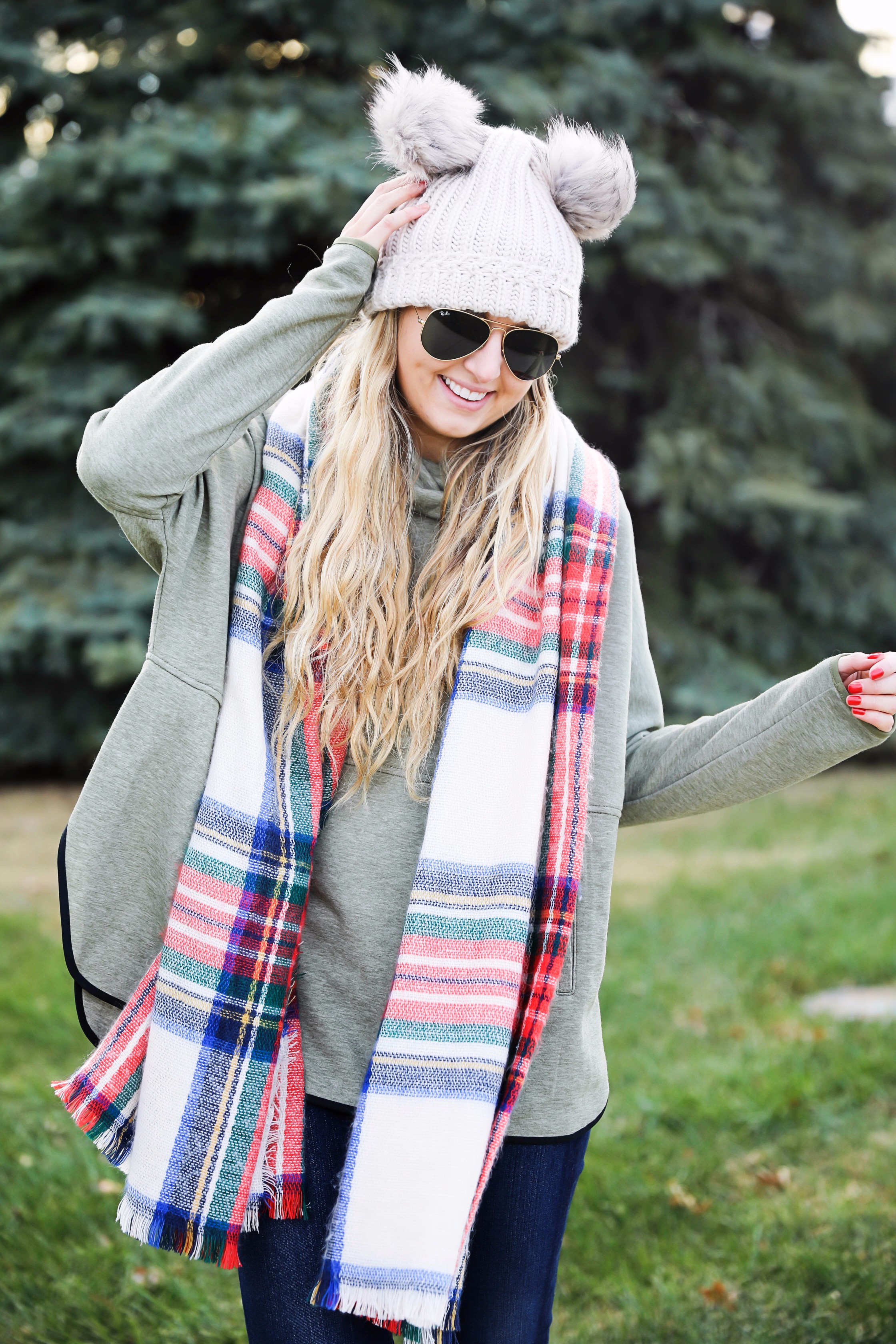 Christmas colored plaid scarf paired with my olive north face and faux fur ear beanie! Wearing my green hunter boots to make this look a casual holiday outfit! Details on daily dose of charm by lauren lindmark