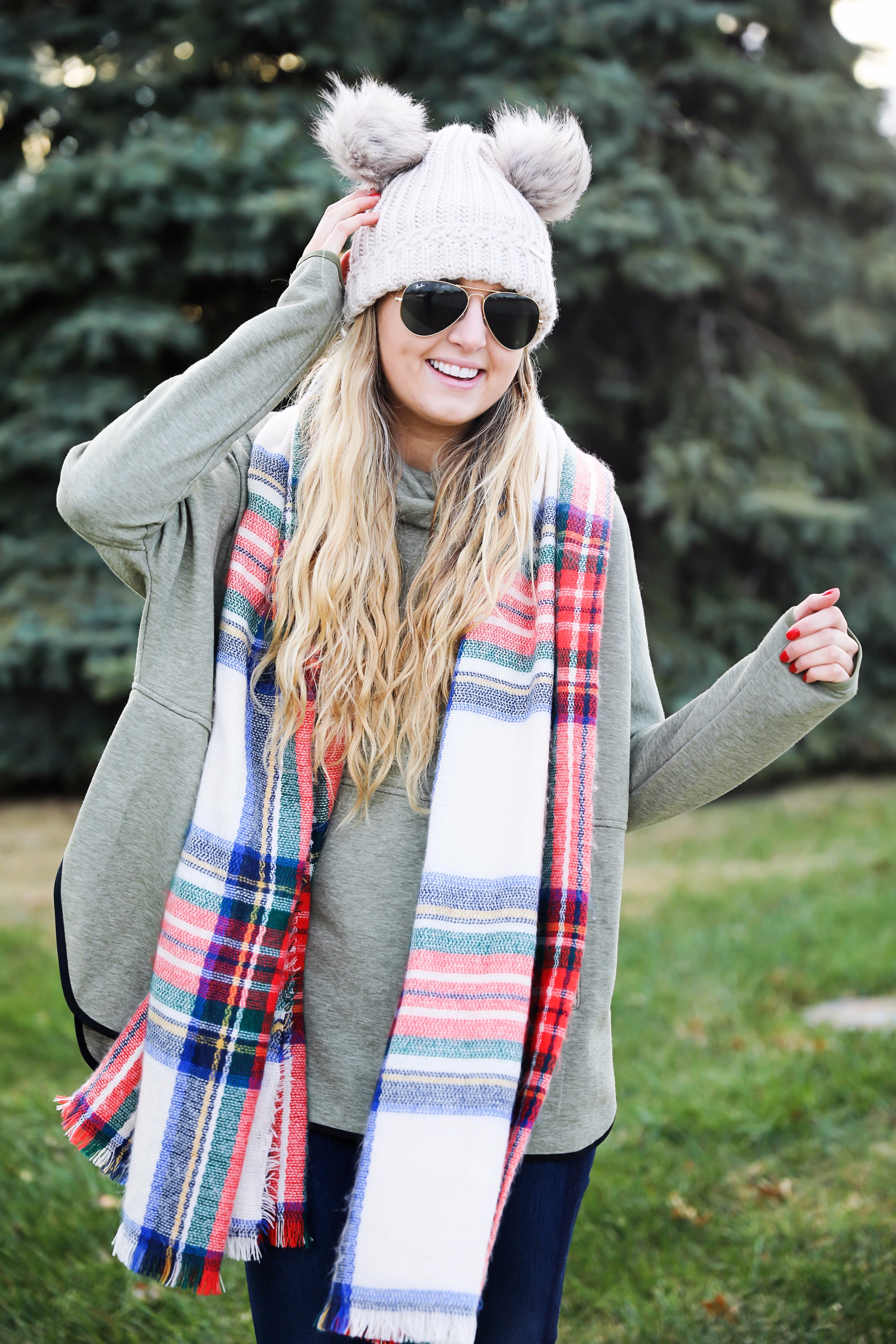 Christmas colored plaid scarf paired with my olive north face and faux fur ear beanie! Wearing my green hunter boots to make this look a casual holiday outfit! Details on daily dose of charm by lauren lindmark