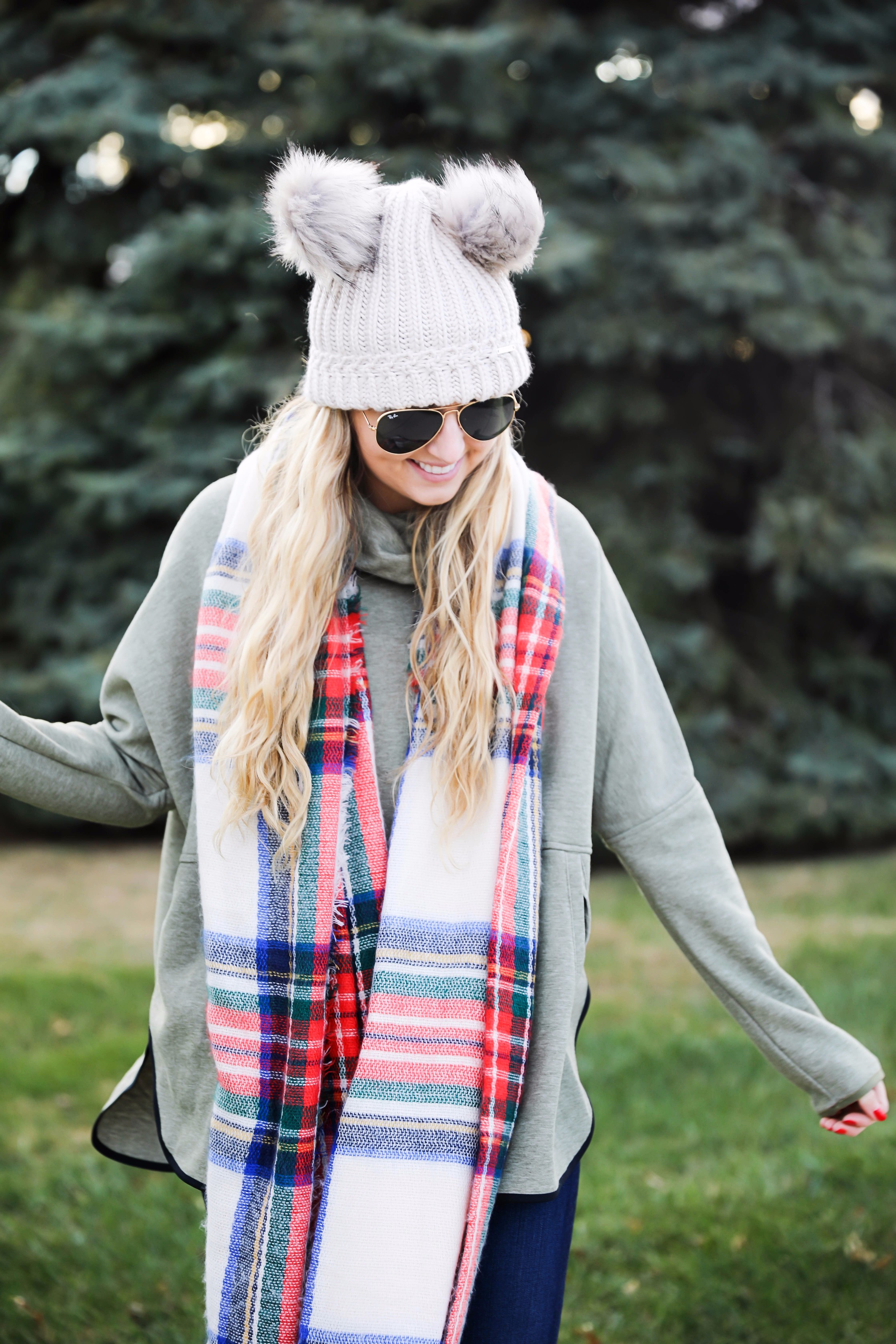 Christmas colored plaid scarf paired with my olive north face and faux fur ear beanie! Wearing my green hunter boots to make this look a casual holiday outfit! Details on daily dose of charm by lauren lindmark