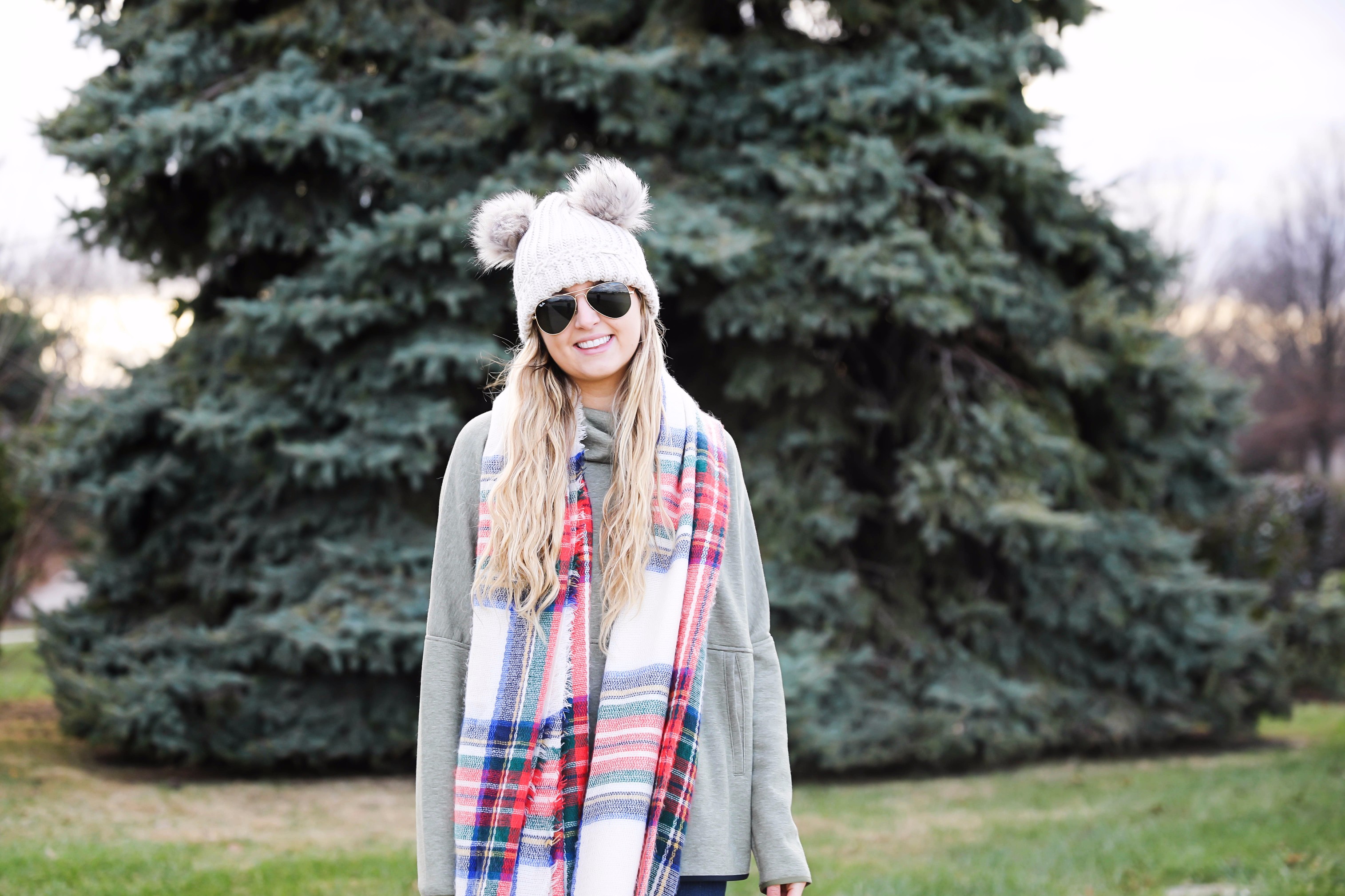 Christmas colored plaid scarf paired with my olive north face and faux fur ear beanie! Wearing my green hunter boots to make this look a casual holiday outfit! Details on daily dose of charm by lauren lindmark