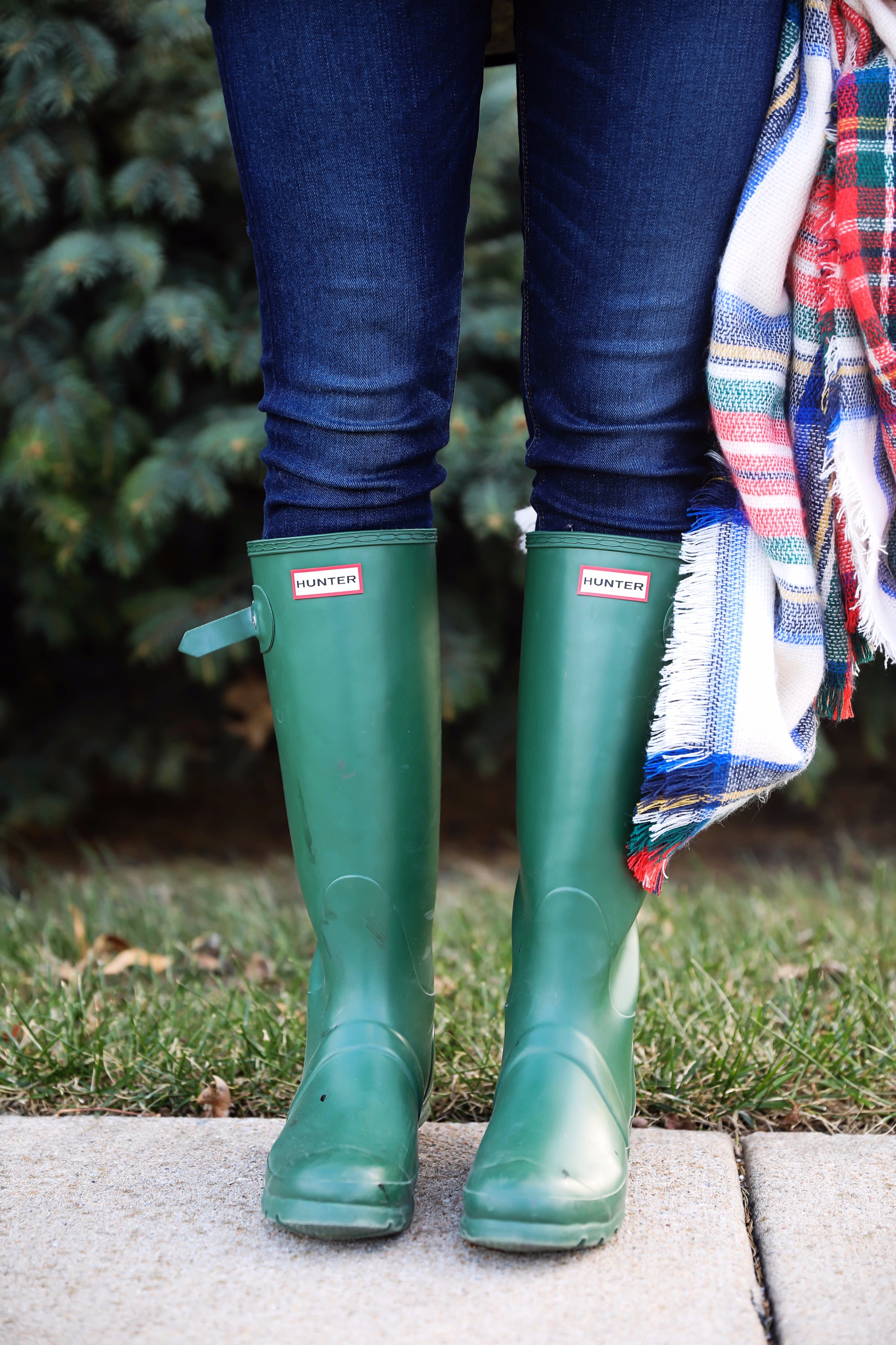 Christmas colored plaid scarf paired with my olive north face and faux fur ear beanie! Wearing my green hunter boots to make this look a casual holiday outfit! Details on daily dose of charm by lauren lindmark