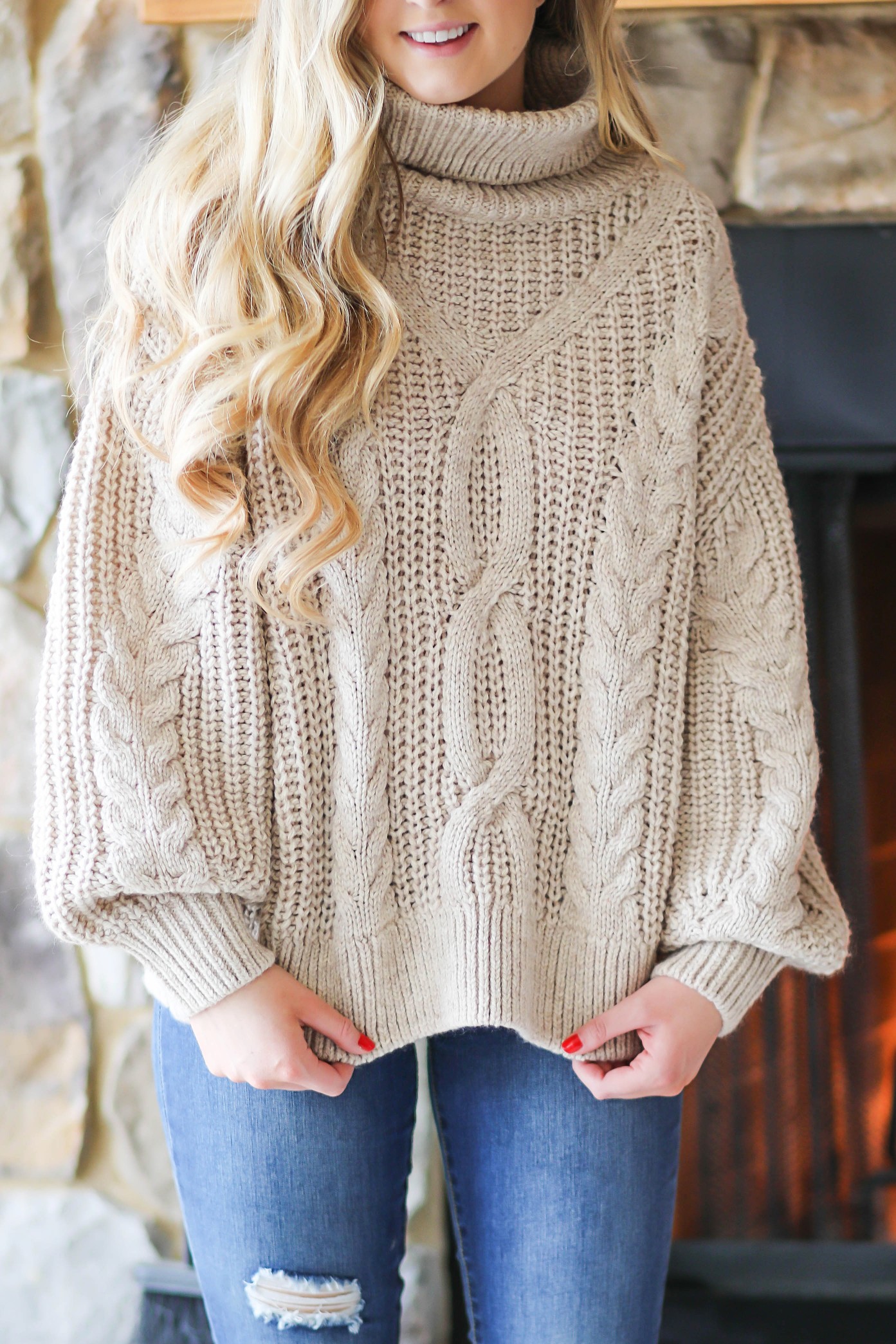 Cozy cable knit sweater in front of stone fireplace! This winter cable knit sweater is so cute and the fire looks so inviting! I paired it with my L.L. Bean duck Boots! Details on fashion blog daily dose of charm by lauren lindmark