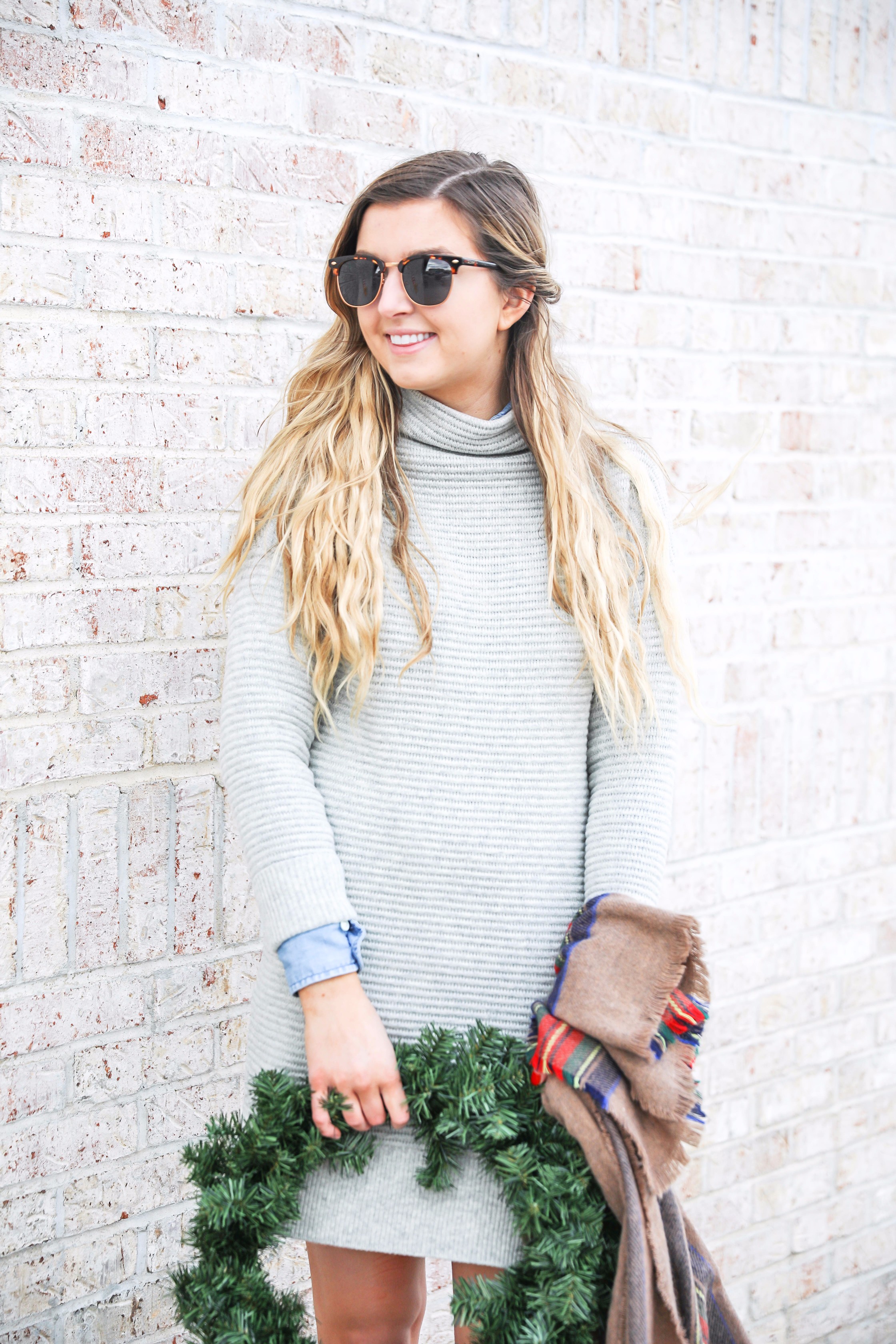 Grey sweater dress layered wtih a chambray top and plaid scarf! Paired with my favorite riding boots by frye boots! Photos taken with a christmas wreath. Christmas wreath photos by lauren lindmark on the blog daily dose of charm