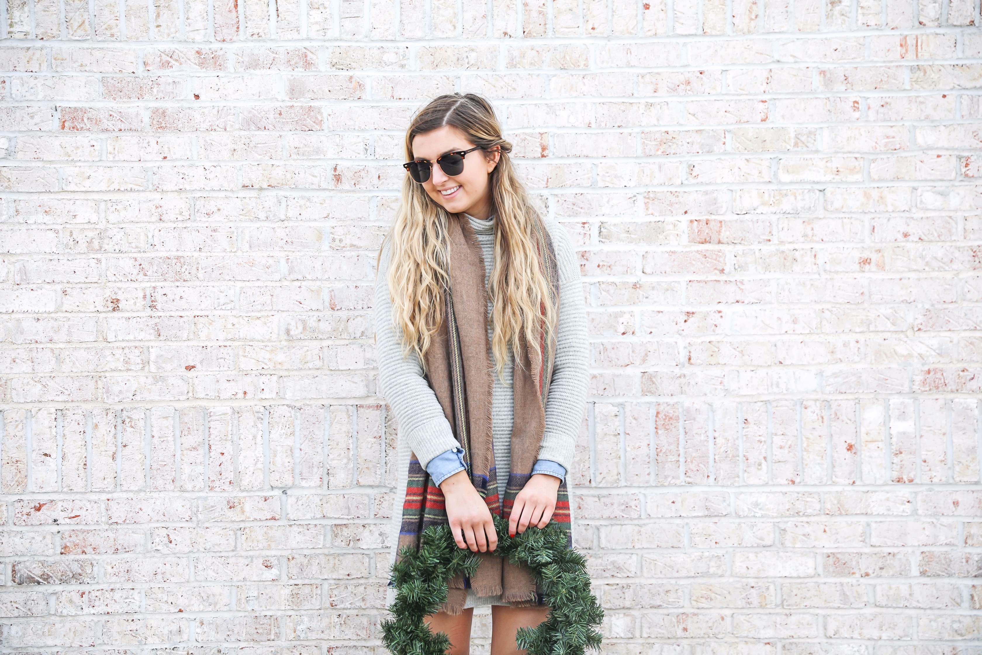 Grey sweater dress layered wtih a chambray top and plaid scarf! Paired with my favorite riding boots by frye boots! Photos taken with a christmas wreath. Christmas wreath photos by lauren lindmark on the blog daily dose of charm
