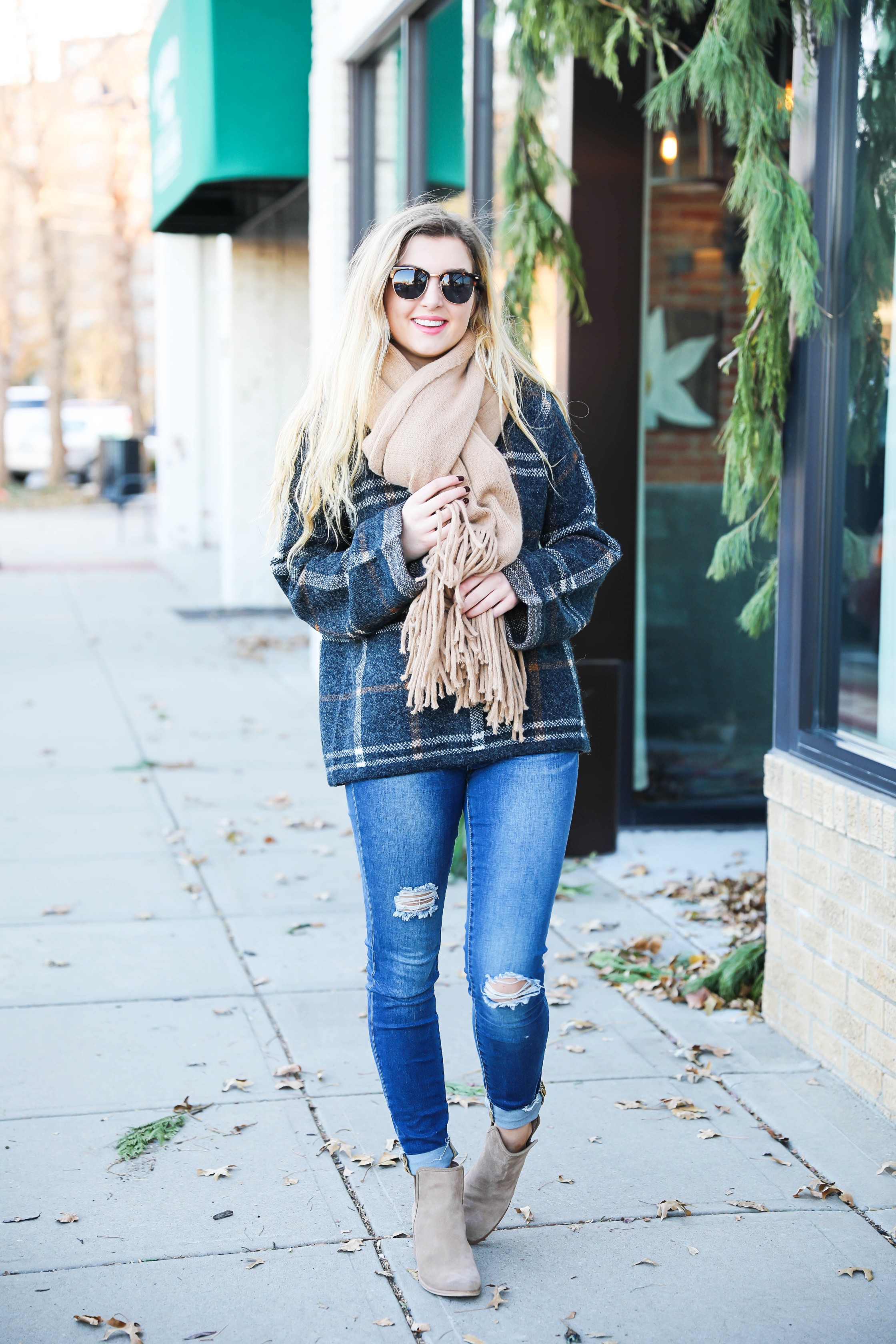 Plaid sweater with fringe free people scarf! Super cute winter outfit idea! Get all the details on fashion blog daily dose of charm by Lauren Lindmark