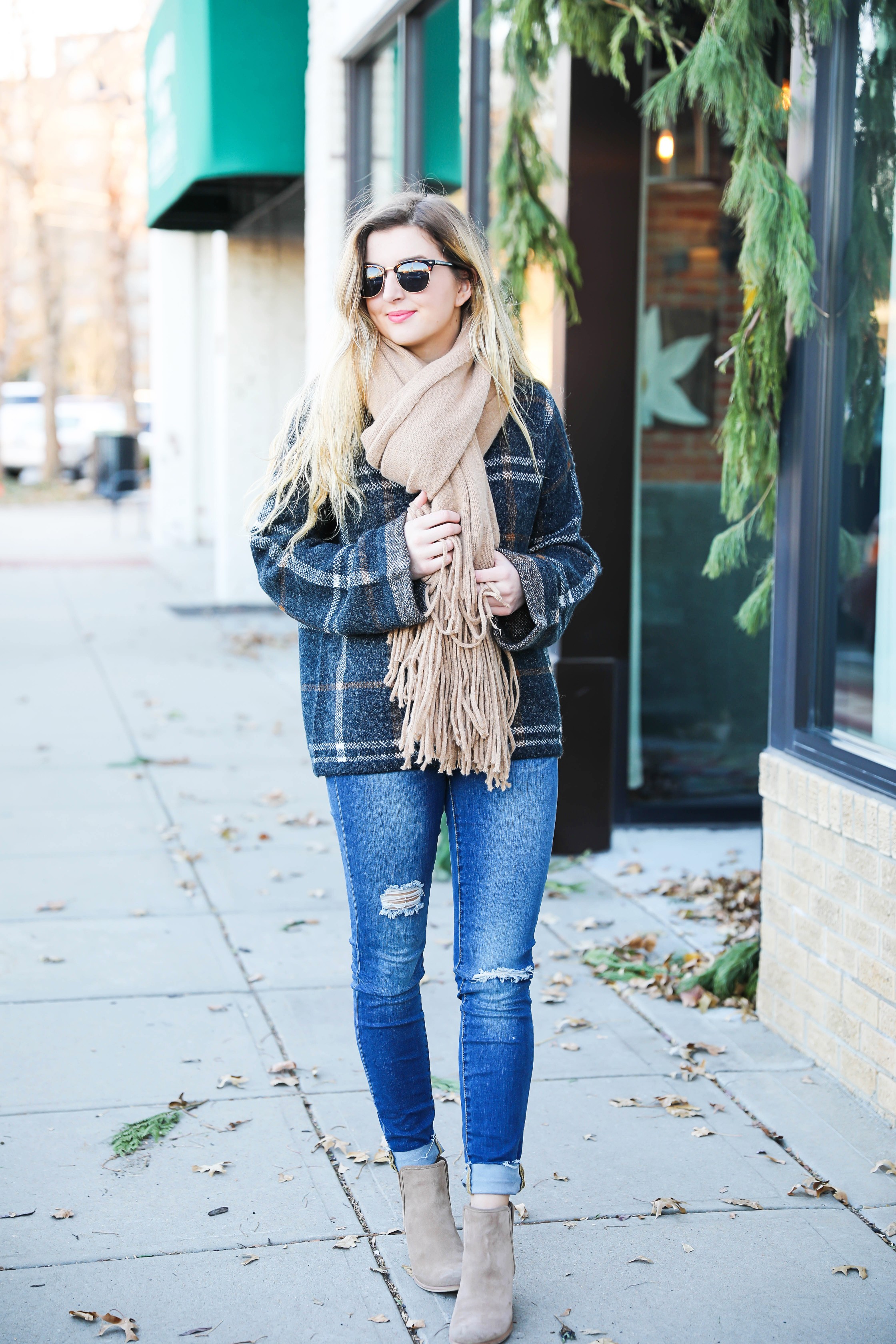 Plaid sweater with fringe free people scarf! Super cute winter outfit idea! Get all the details on fashion blog daily dose of charm by Lauren Lindmark