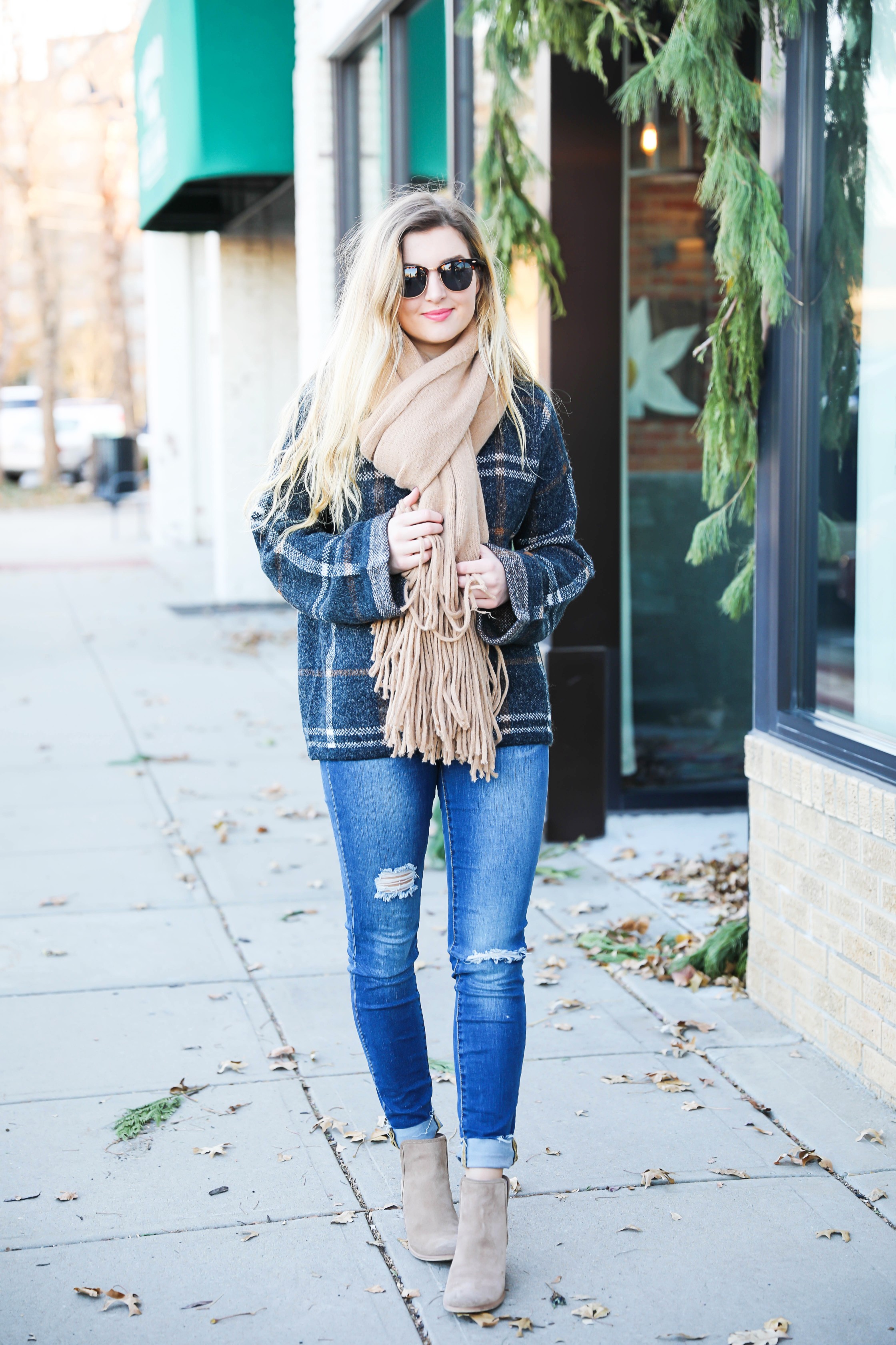 Plaid sweater with fringe free people scarf! Super cute winter outfit idea! Get all the details on fashion blog daily dose of charm by Lauren Lindmark