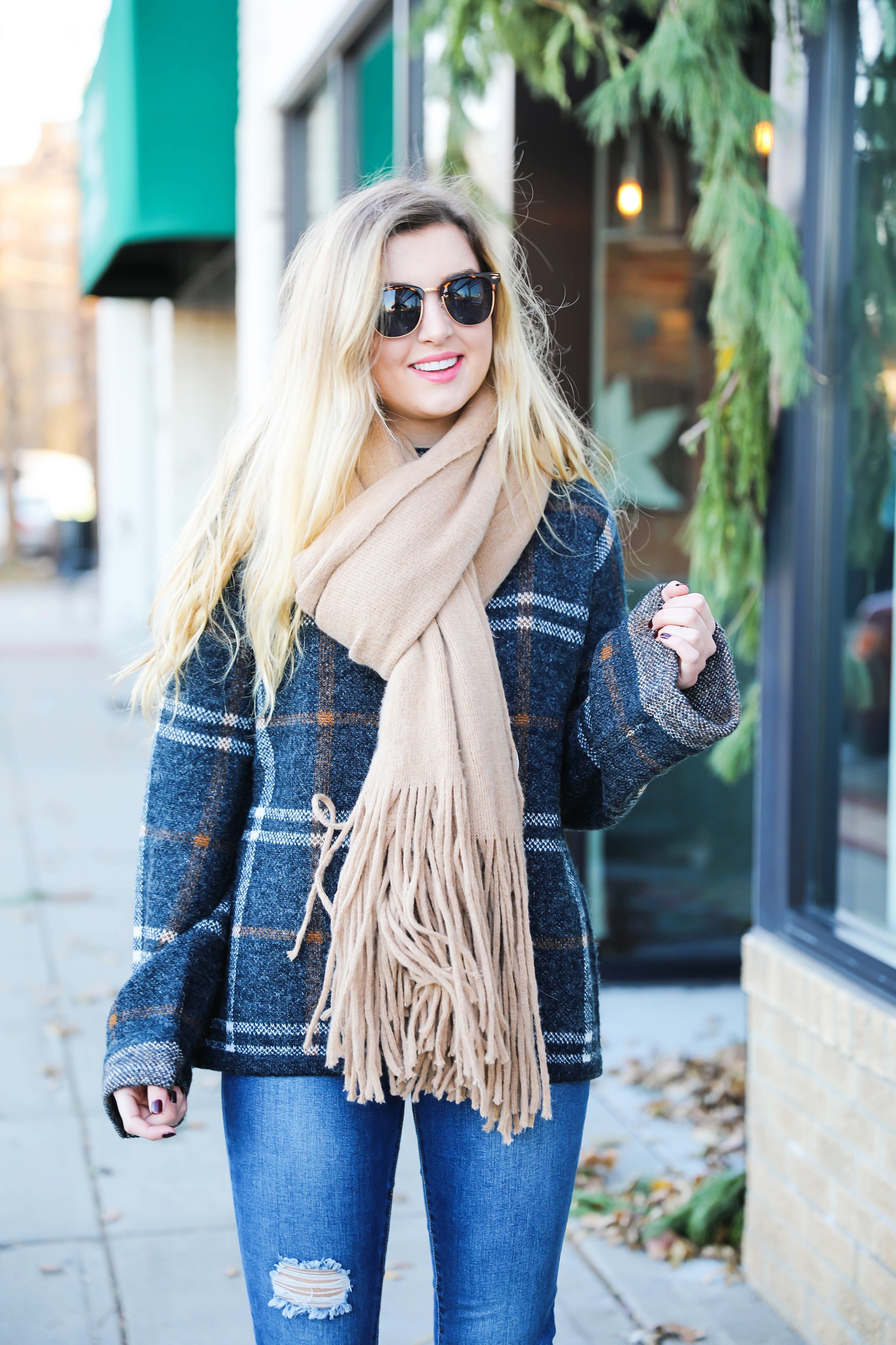Plaid sweater with fringe free people scarf! Super cute winter outfit idea! Get all the details on fashion blog daily dose of charm by Lauren Lindmark