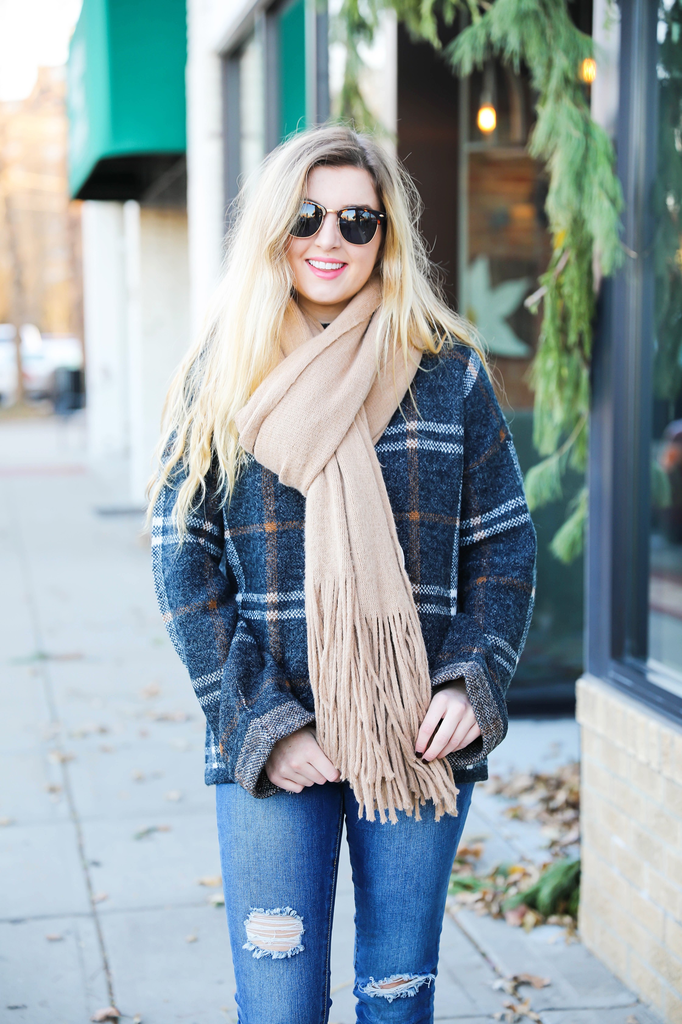 Plaid sweater with fringe free people scarf! Super cute winter outfit idea! Get all the details on fashion blog daily dose of charm by Lauren Lindmark