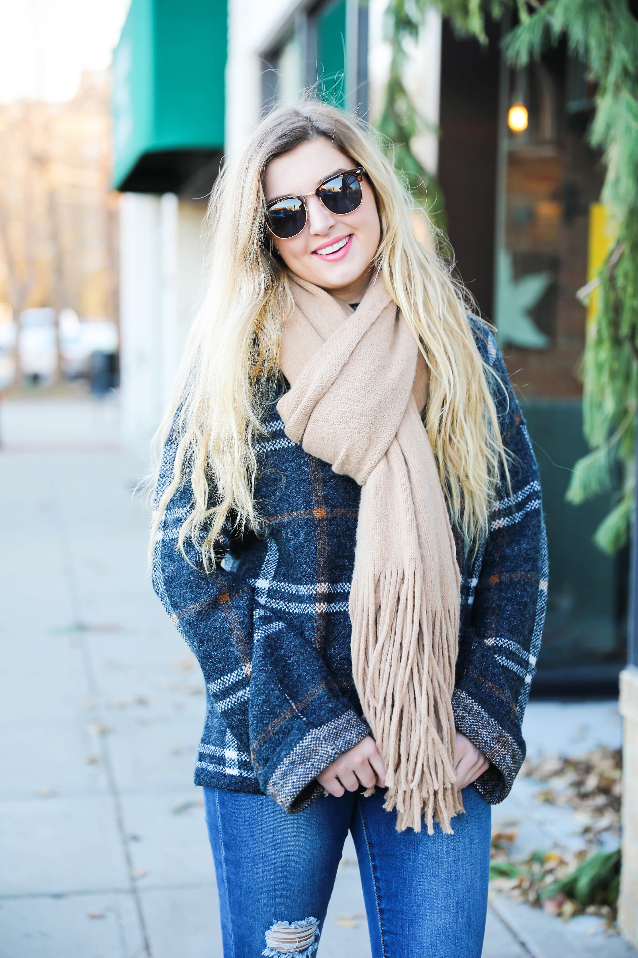 Plaid sweater with fringe free people scarf! Super cute winter outfit idea! Get all the details on fashion blog daily dose of charm by Lauren Lindmark