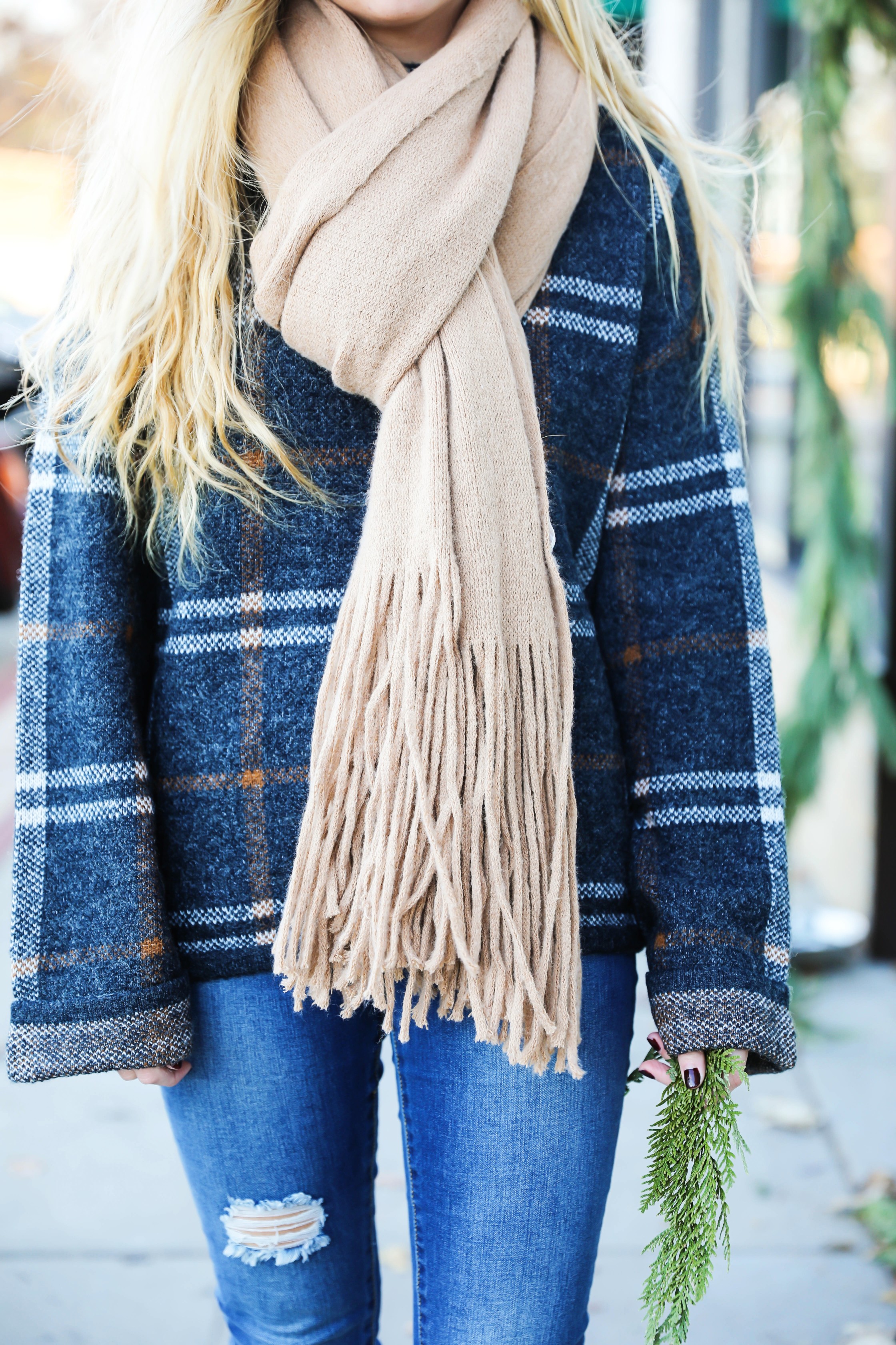 Plaid sweater with fringe free people scarf! Super cute winter outfit idea! Get all the details on fashion blog daily dose of charm by Lauren Lindmark