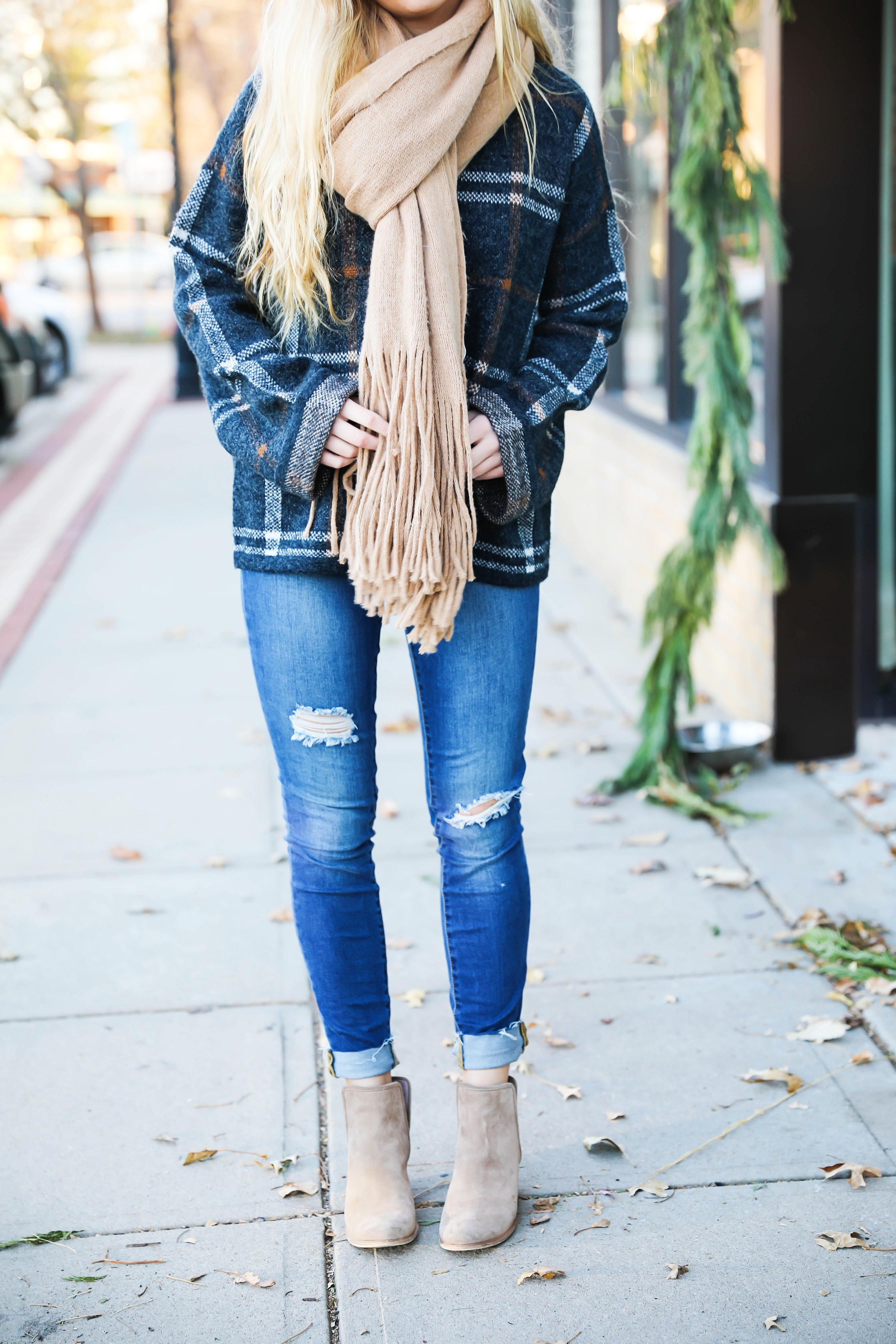 Plaid sweater with fringe free people scarf! Super cute winter outfit idea! Get all the details on fashion blog daily dose of charm by Lauren Lindmark