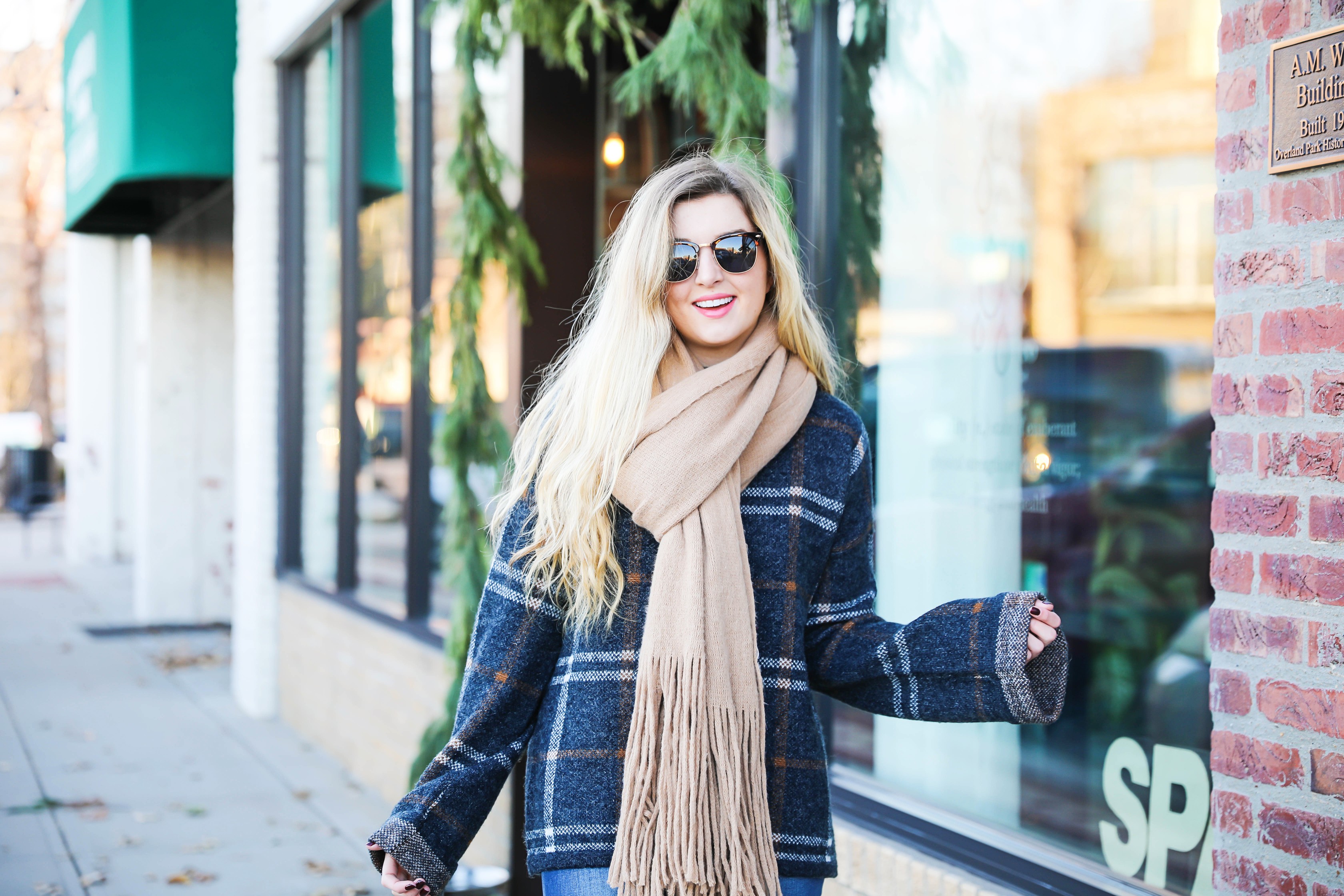 Plaid sweater with fringe free people scarf! Super cute winter outfit idea! Get all the details on fashion blog daily dose of charm by Lauren Lindmark