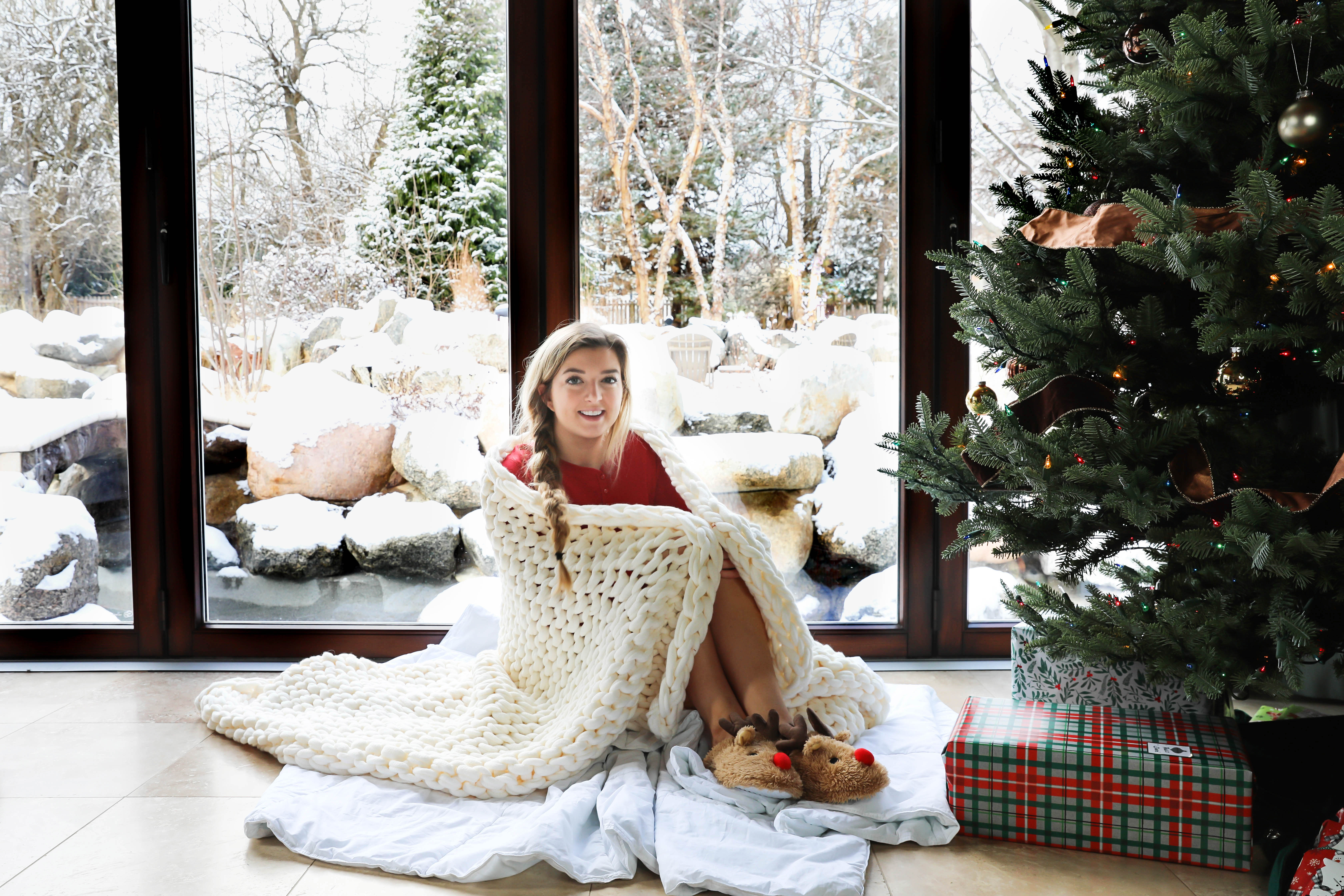 Snowy Christmas Windows and knit blanket by the christmas tree on fashion blog daily dose of charm by lauren lindmark