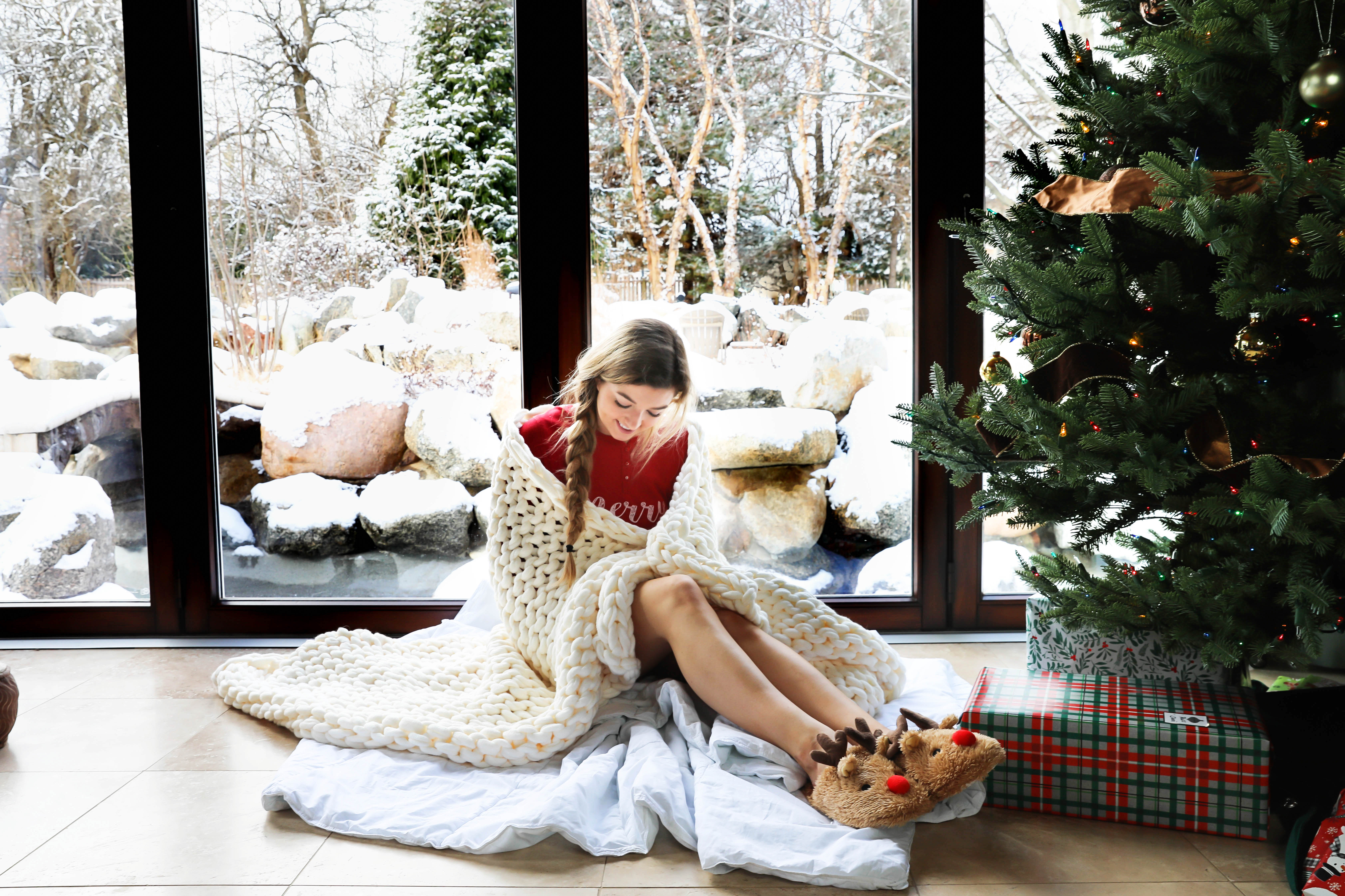 Snowy Christmas Windows and knit blanket by the christmas tree on fashion blog daily dose of charm by lauren lindmark
