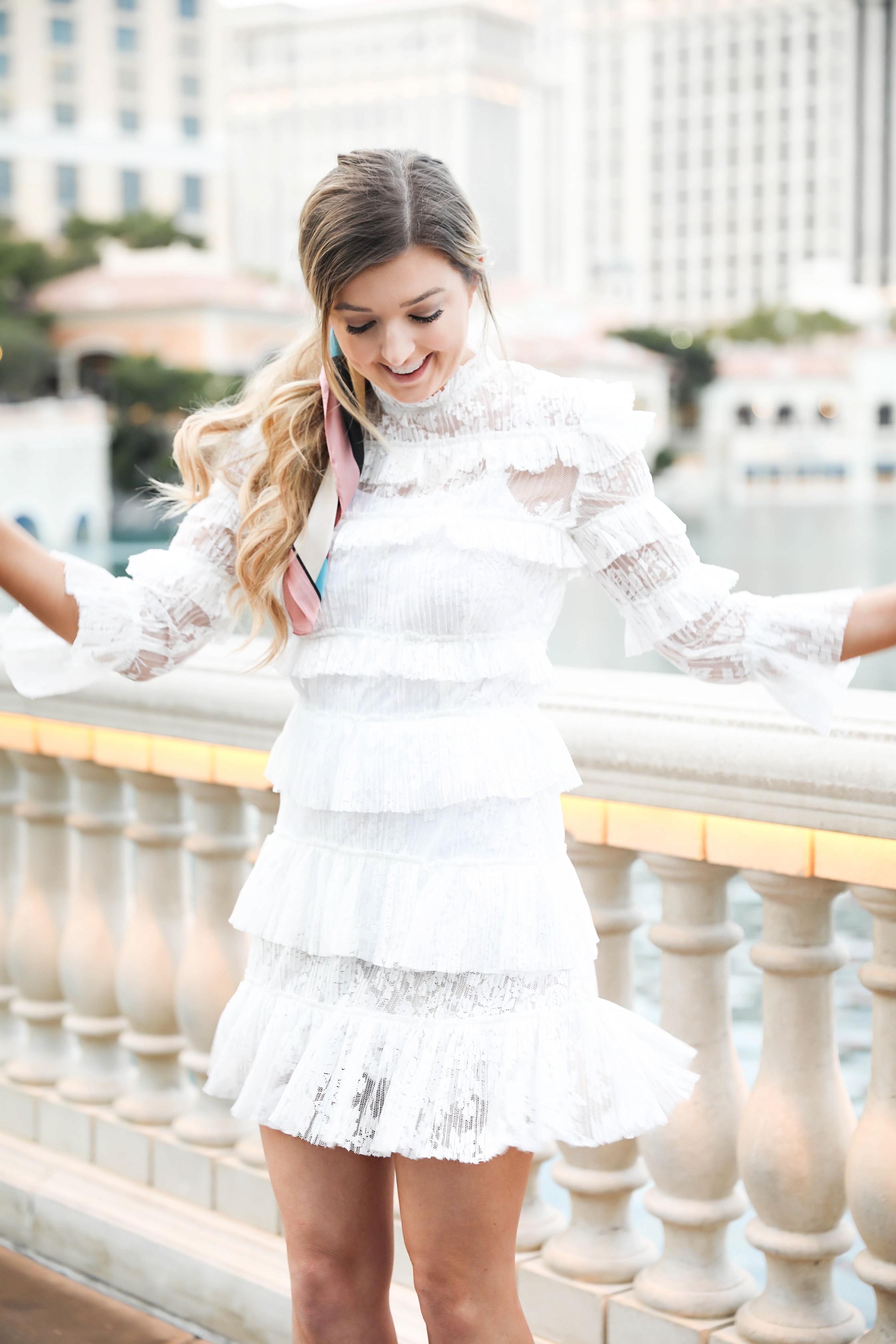 Bellagio fountains in Las Vegas! Wearing a white lace dress and scarf in my pony tail! Las Vegas style! Las vegas blogger! Details on daily dose of charm by lauren lindmark