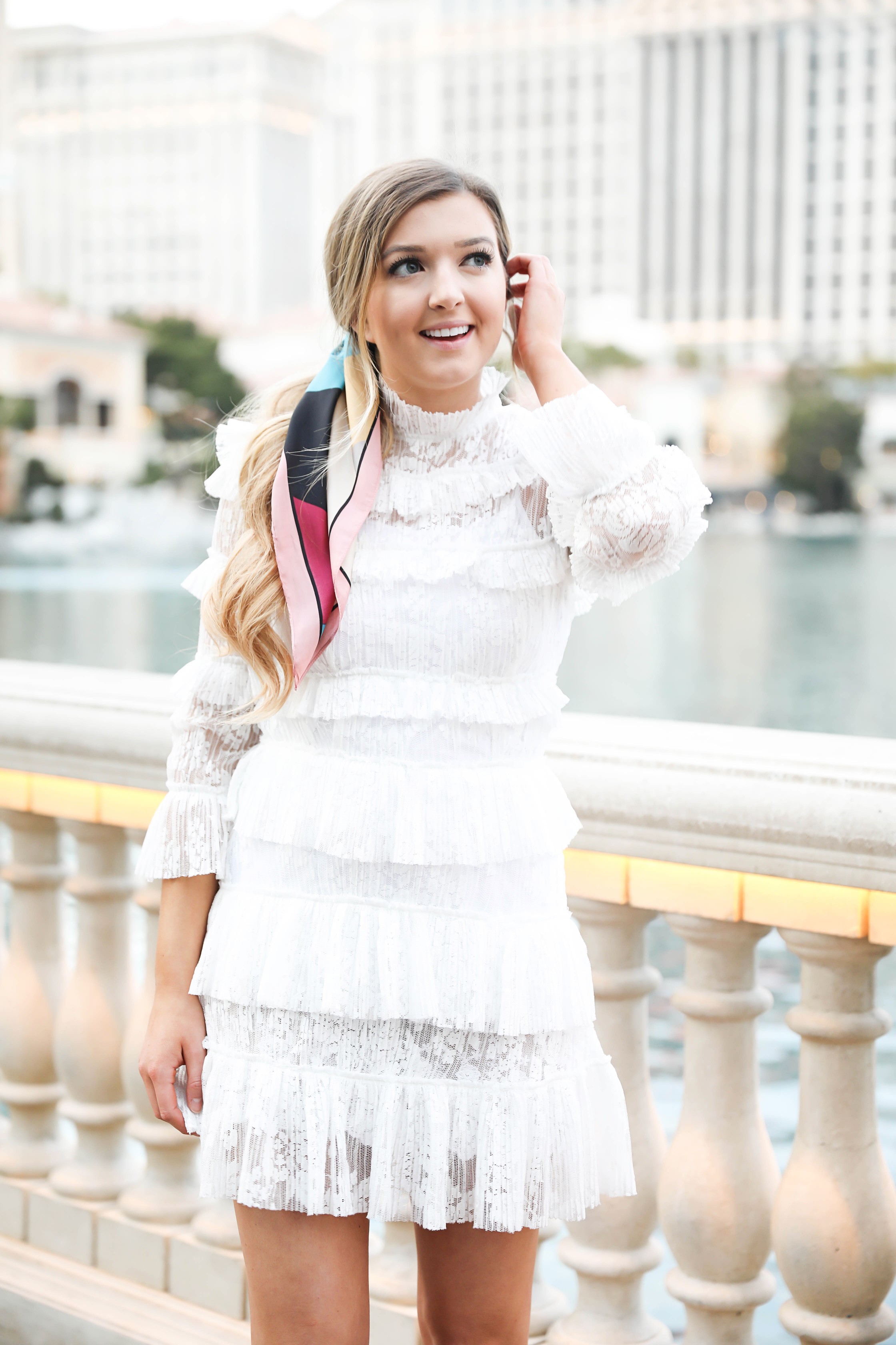 Bellagio fountains in Las Vegas! Wearing a white lace dress and scarf in my pony tail! Las Vegas style! Las vegas blogger! Details on daily dose of charm by lauren lindmark