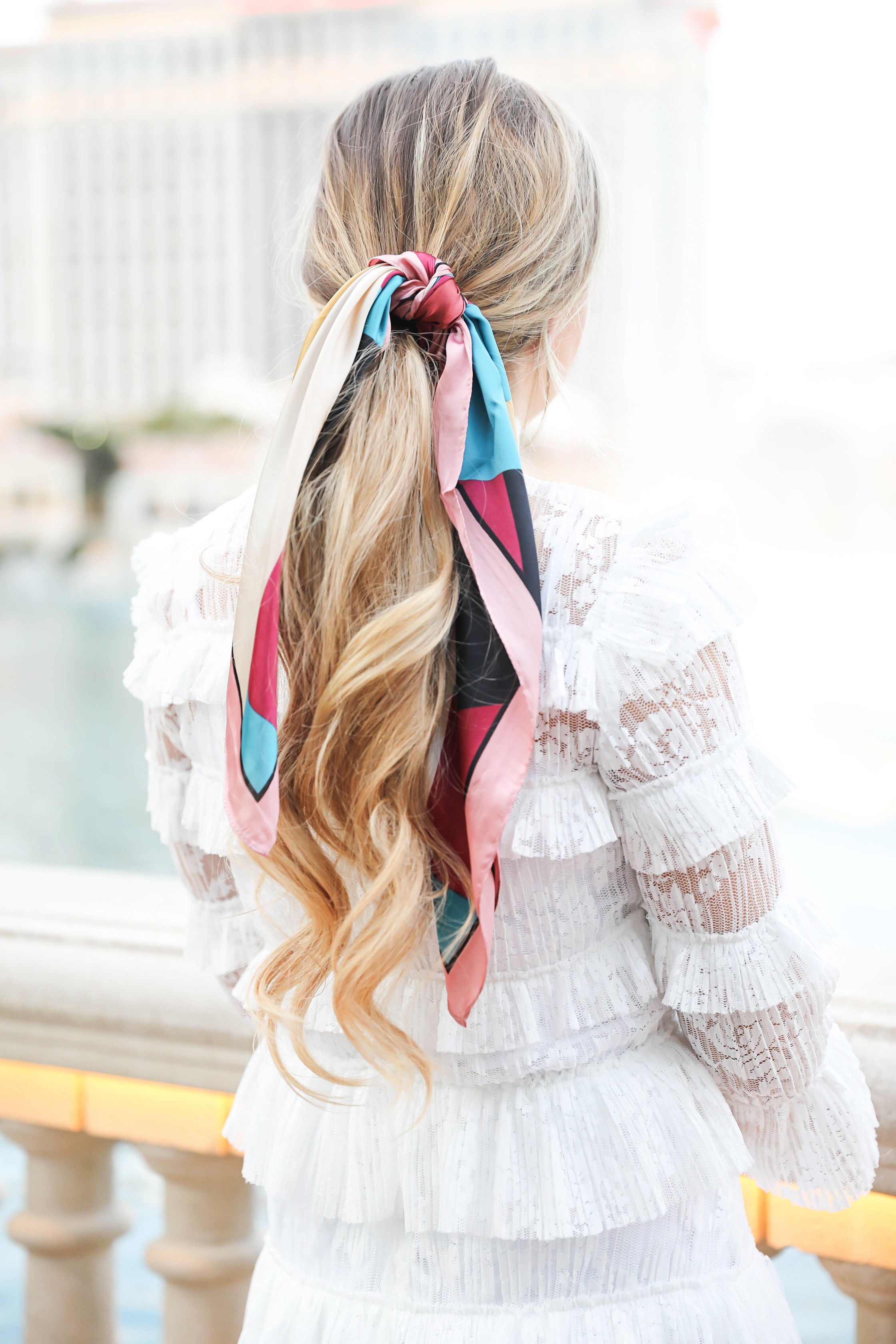 Bellagio fountains in Las Vegas! Wearing a white lace dress and scarf in my pony tail! Las Vegas style! Las vegas blogger! Details on daily dose of charm by lauren lindmark