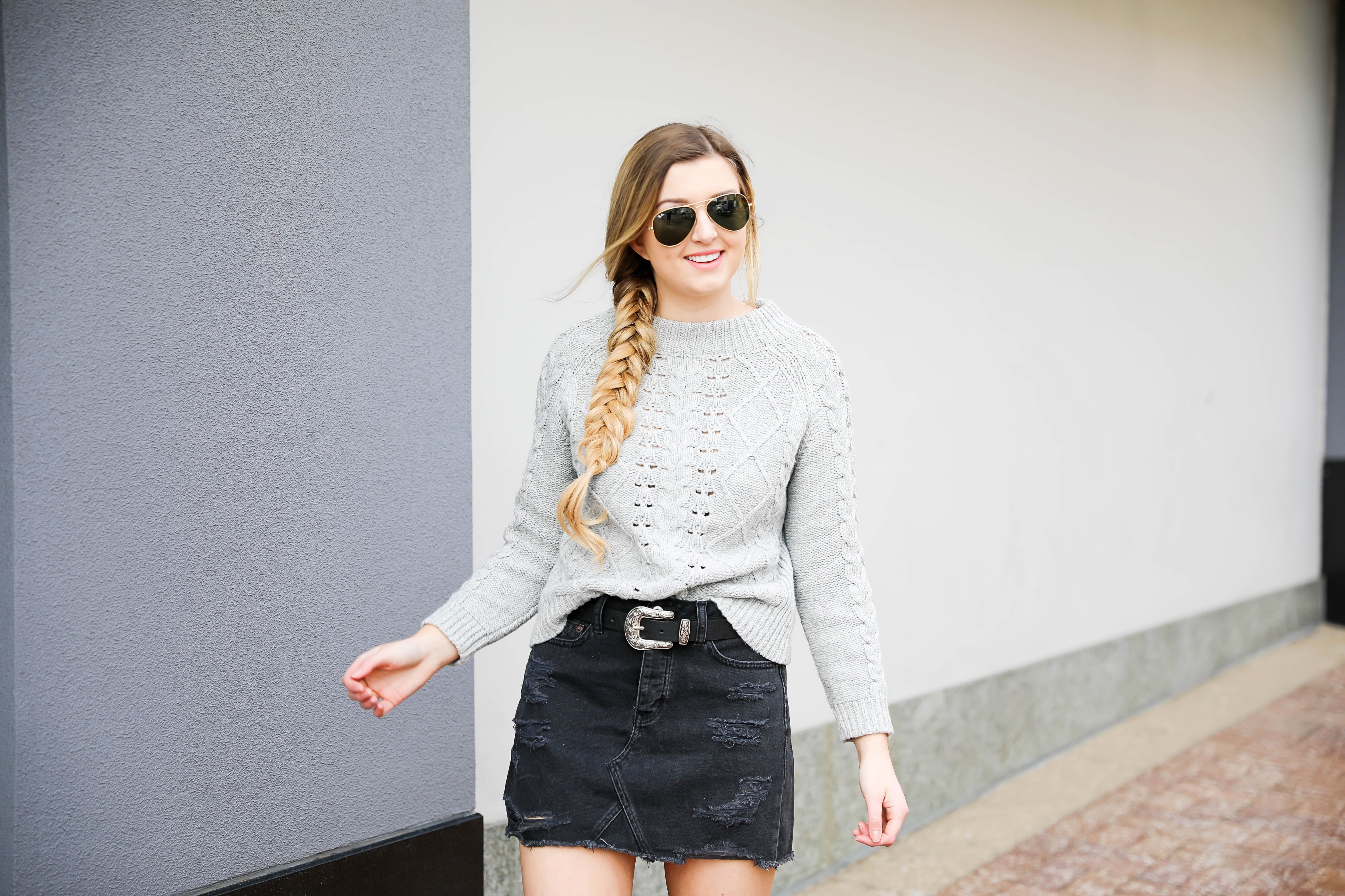 Edgy meets cozy! Adorable ripped black denim skirt with over the knee black boots! Paired with a cozy grey J.Crew cable knit sweater! Details on fashion blog daily dose of charm by lauren lindmark