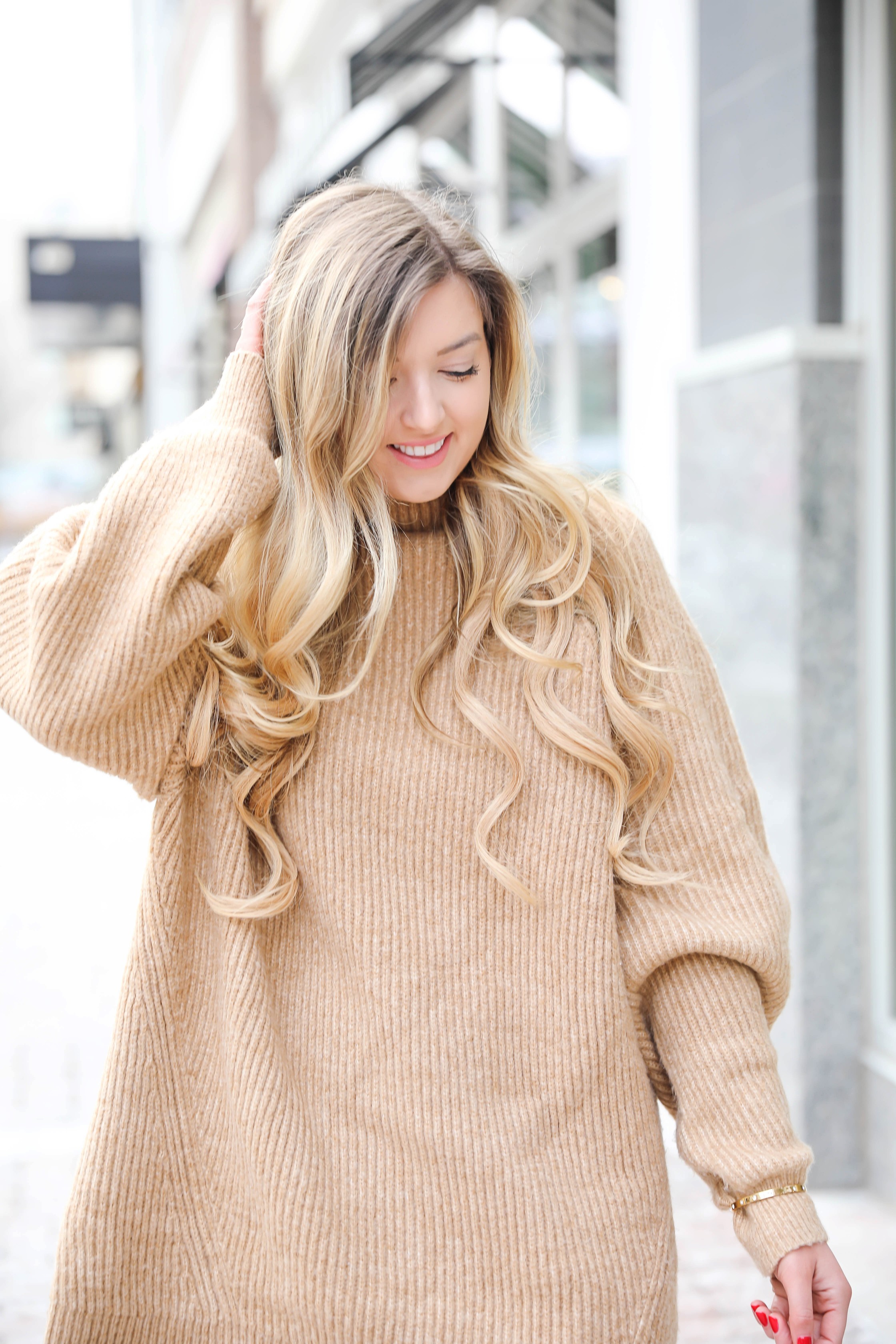 Tan sweater dress from h&m with puffy sleeves. Paired with tan over the knee heeled boots! I love otk boots for winter and spring. Details on fashion blog daily dose of charm by lauren lindmark