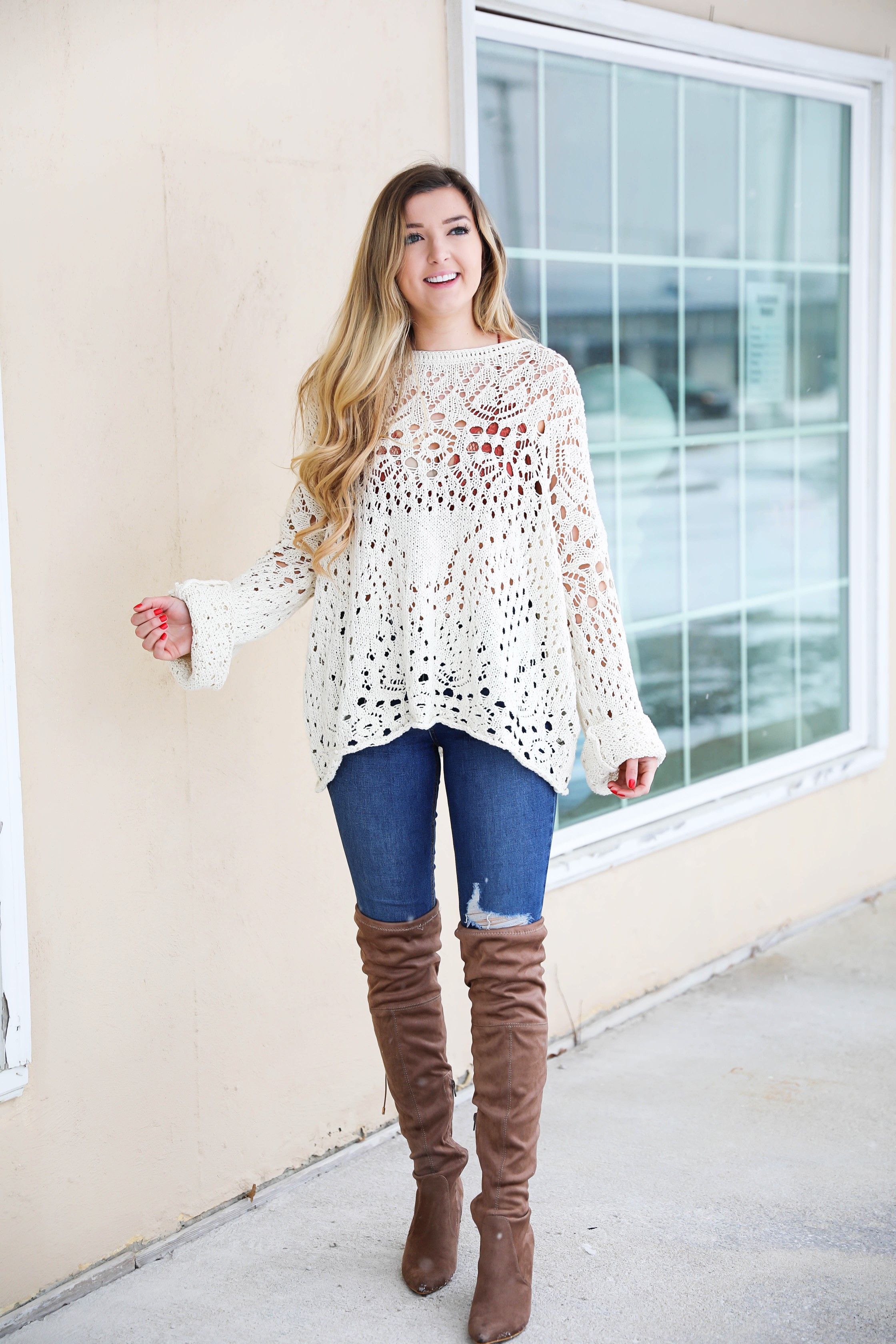 Free People crochet sweater and rust orange bralette peaking through the sweater! Love it with these over the knee boots and ripped denim jeans! Find the details on fashion blog daily dose of charm by lauren lindmark