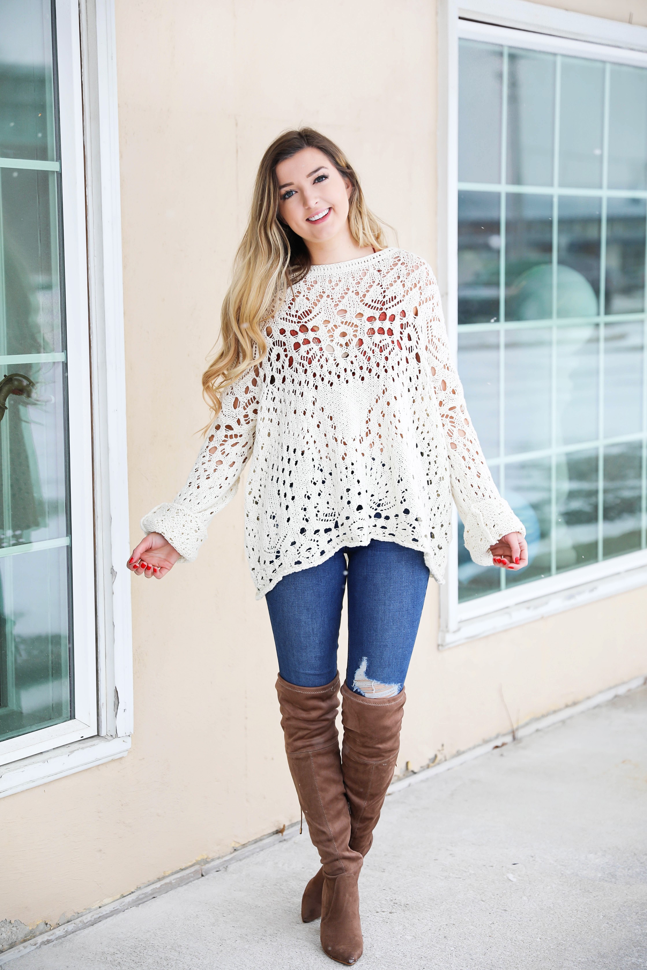 Free People crochet sweater and rust orange bralette peaking through the sweater! Love it with these over the knee boots and ripped denim jeans! Find the details on fashion blog daily dose of charm by lauren lindmark