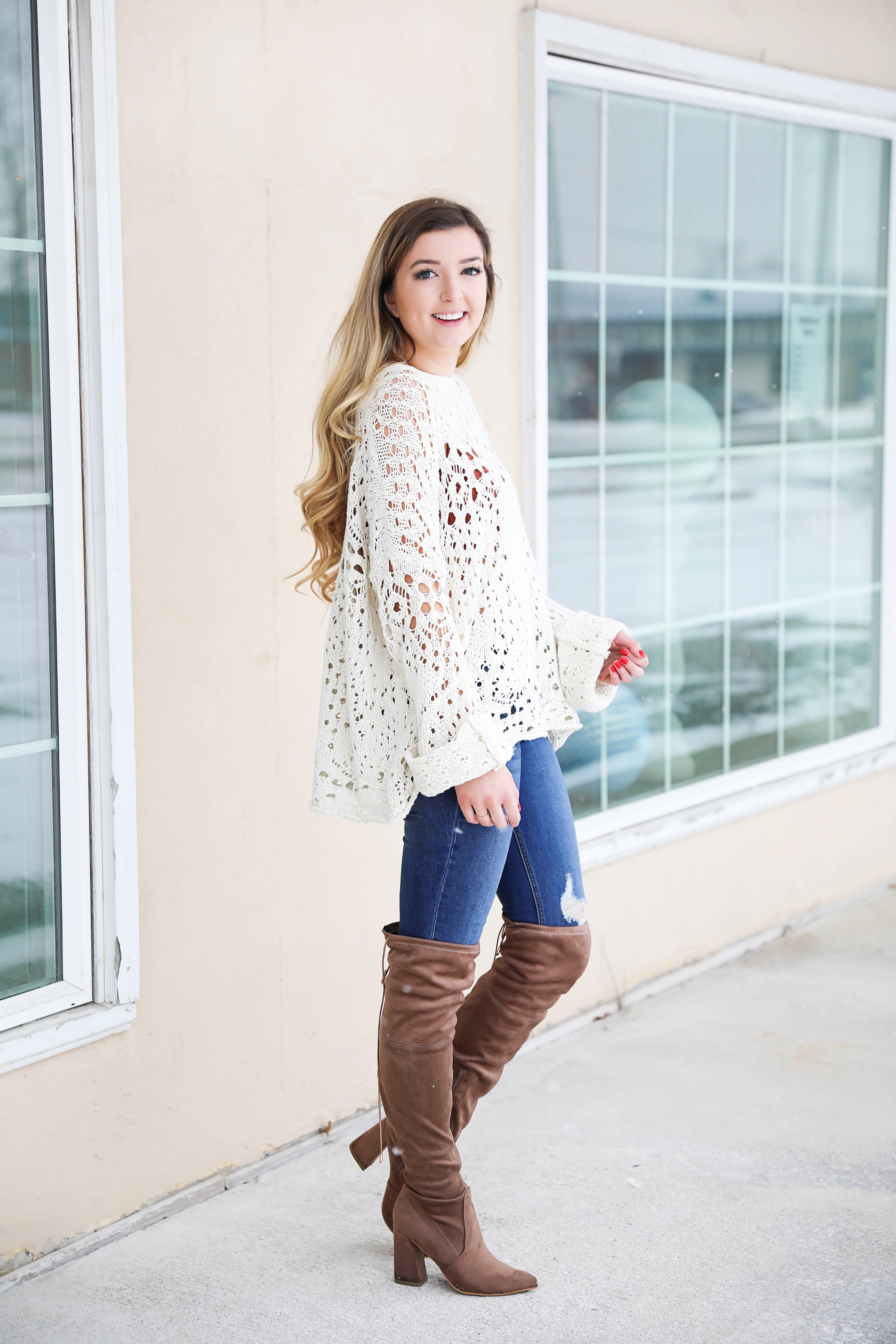 Free People crochet sweater and rust orange bralette peaking through the sweater! Love it with these over the knee boots and ripped denim jeans! Find the details on fashion blog daily dose of charm by lauren lindmark