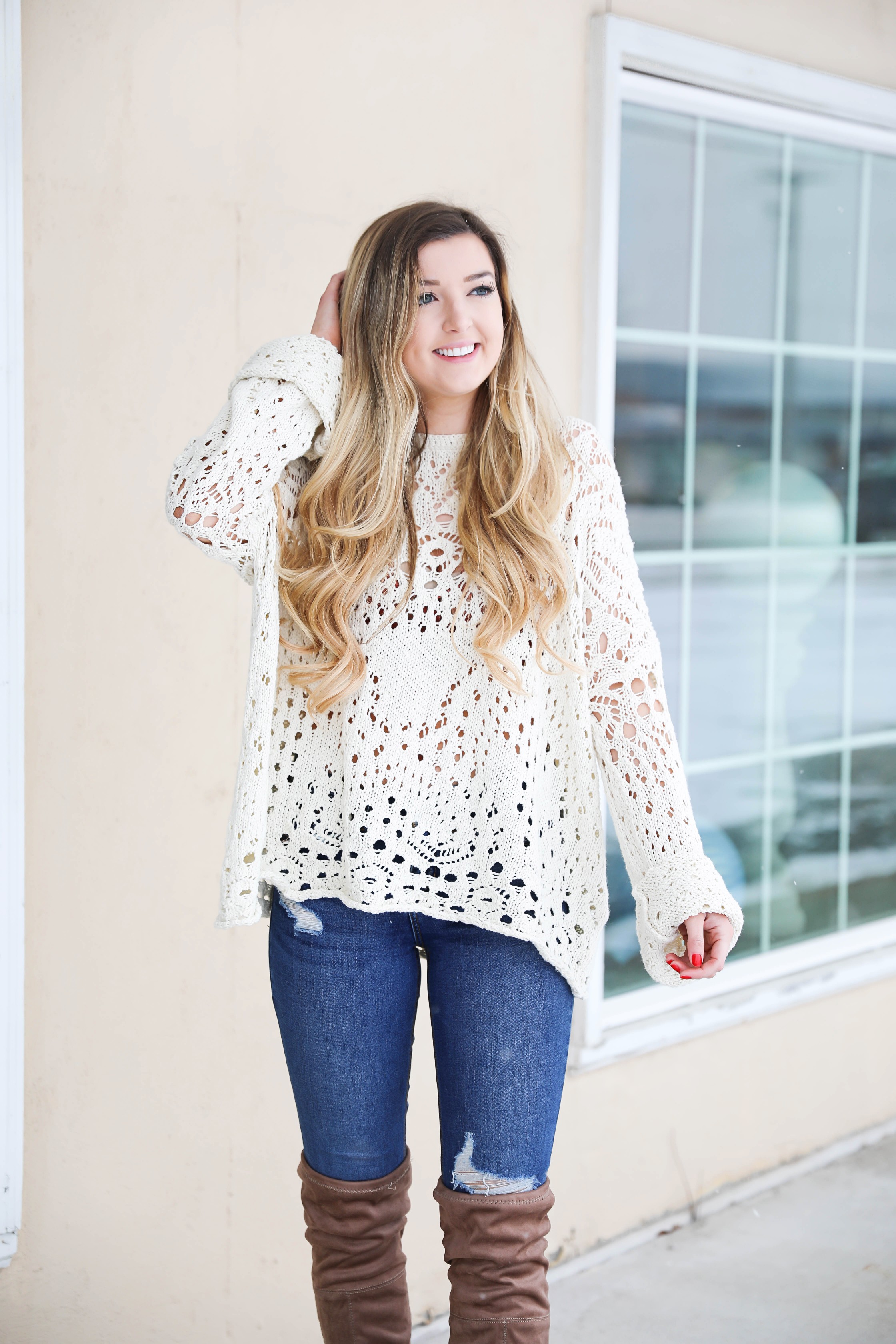 Free People crochet sweater and rust orange bralette peaking through the sweater! Love it with these over the knee boots and ripped denim jeans! Find the details on fashion blog daily dose of charm by lauren lindmark