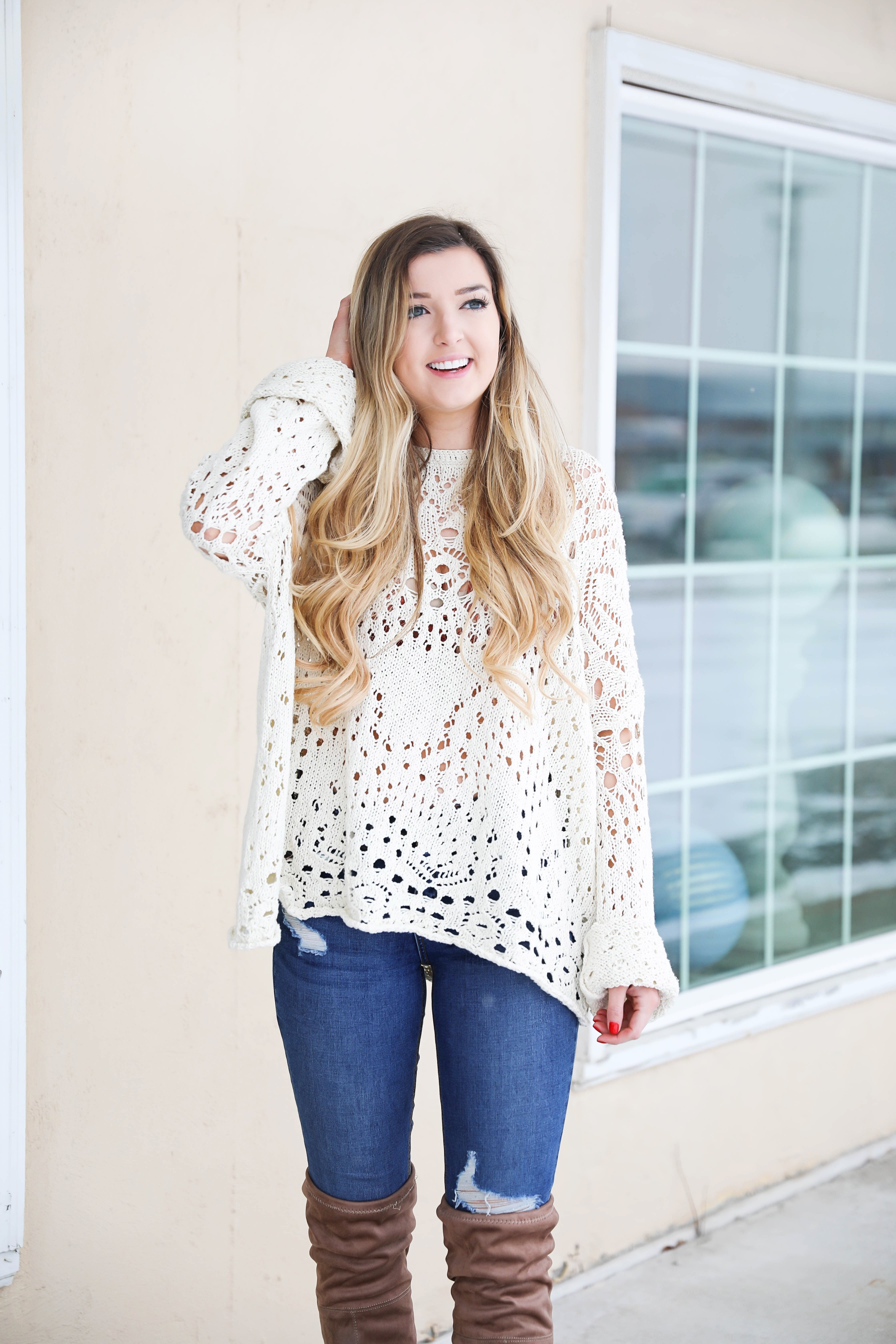 Free People crochet sweater and rust orange bralette peaking through the sweater! Love it with these over the knee boots and ripped denim jeans! Find the details on fashion blog daily dose of charm by lauren lindmark