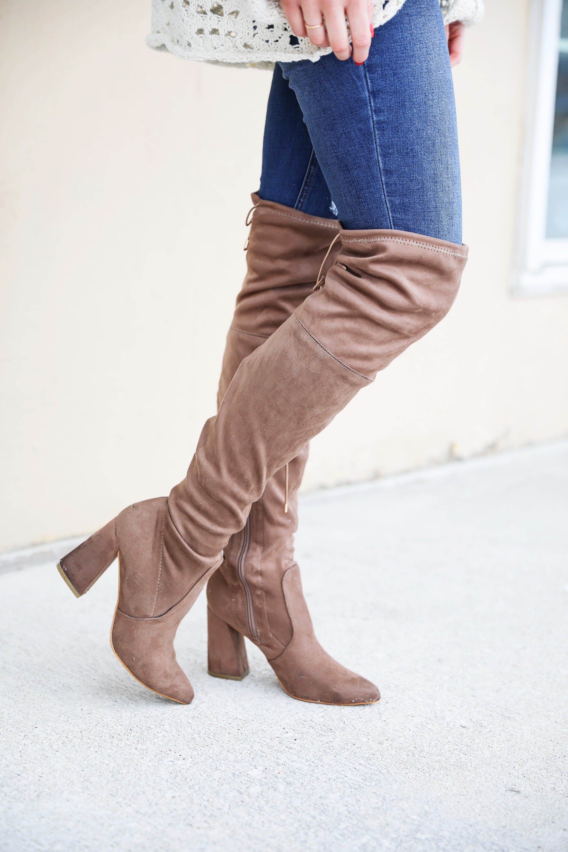 Free People crochet sweater and rust orange bralette peaking through the sweater! Love it with these over the knee boots and ripped denim jeans! Find the details on fashion blog daily dose of charm by lauren lindmark