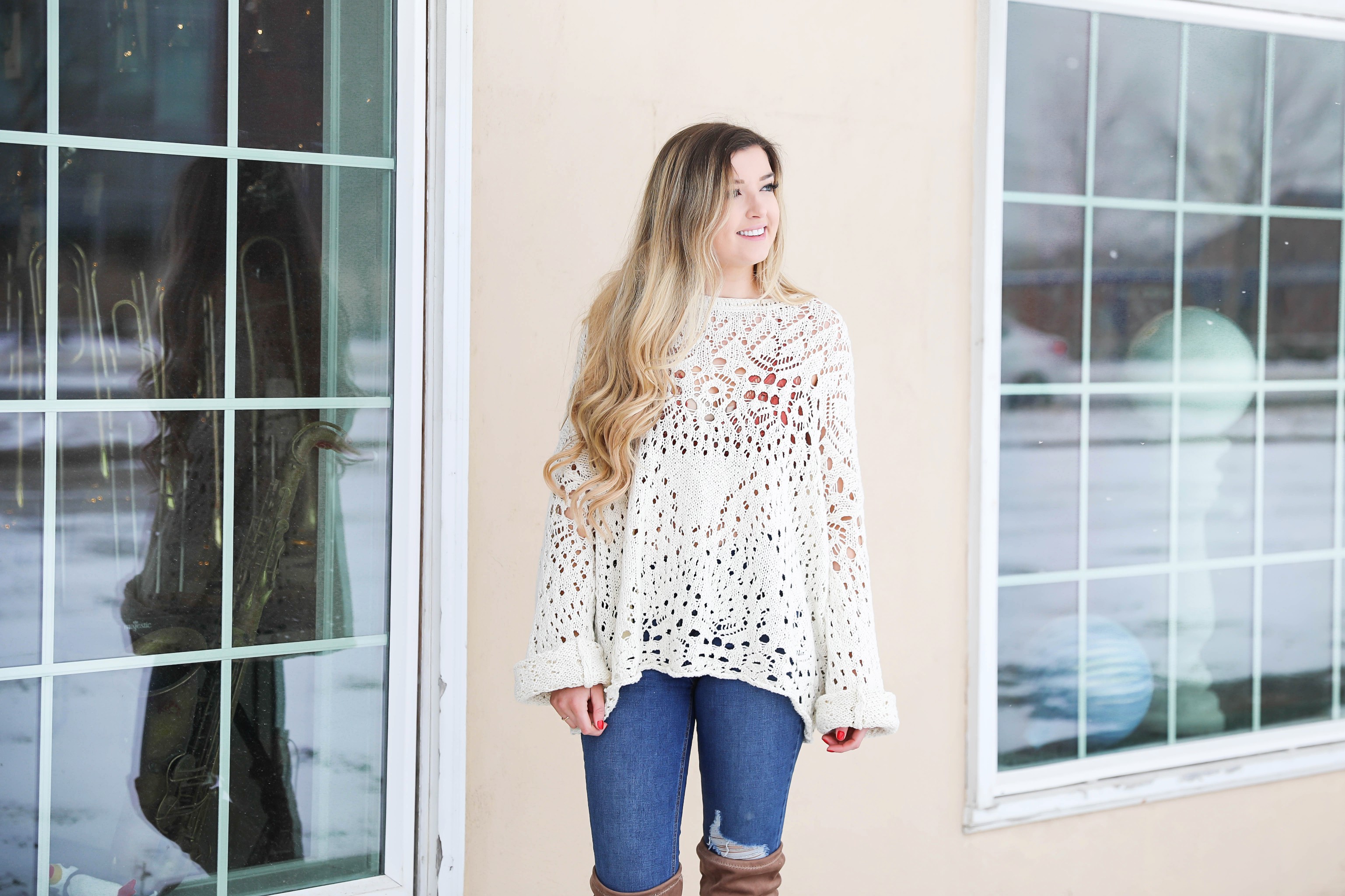 Free People crochet sweater and rust orange bralette peaking through the sweater! Love it with these over the knee boots and ripped denim jeans! Find the details on fashion blog daily dose of charm by lauren lindmark