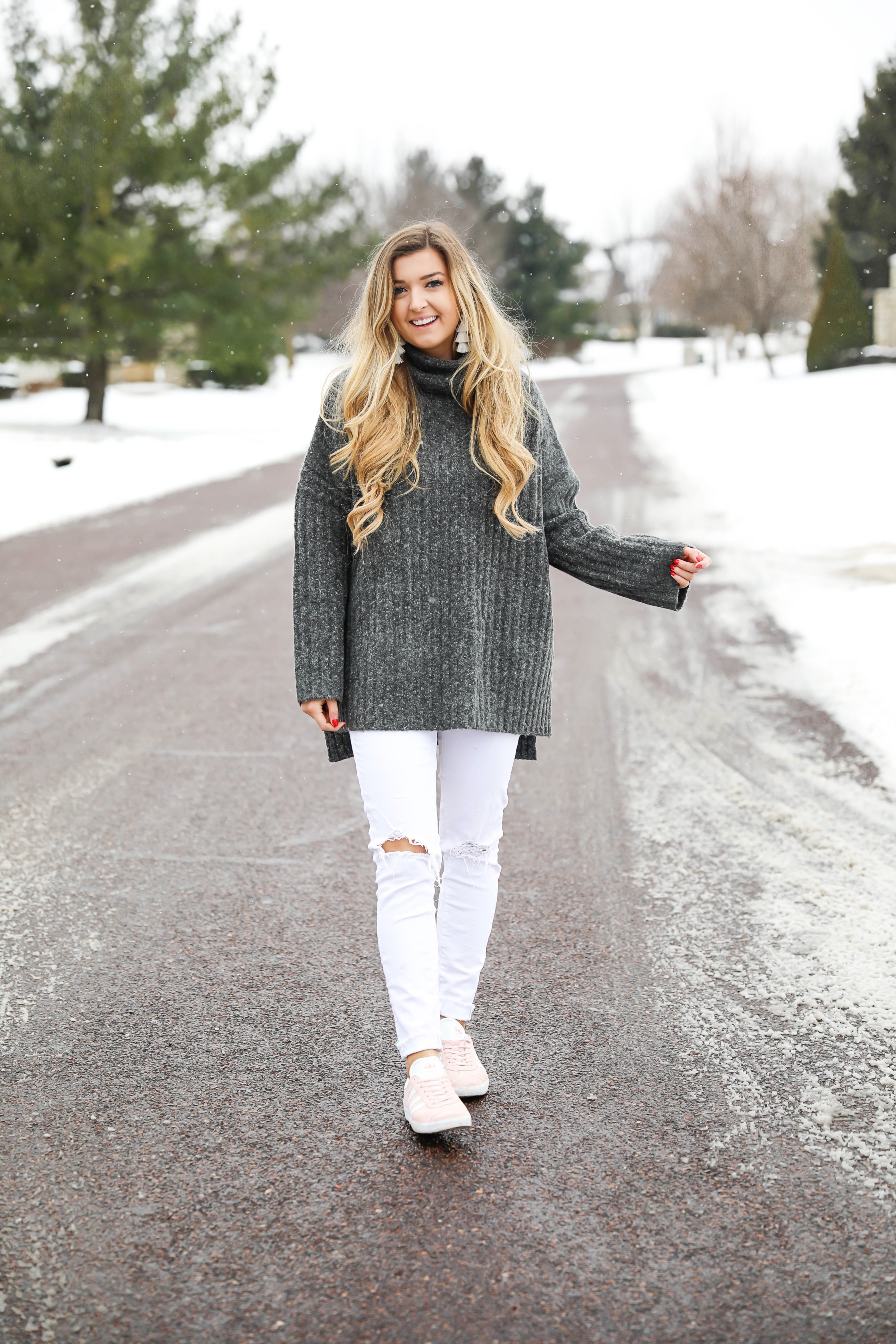 Grey oversized sweater with white jeans and pink sneakers! I paired them with my white earrings and I think it is a perfect outfit to transition into spring! Also a cute Valentine's Day. Details on fashion blog daily dose of charm by lauren lindmark