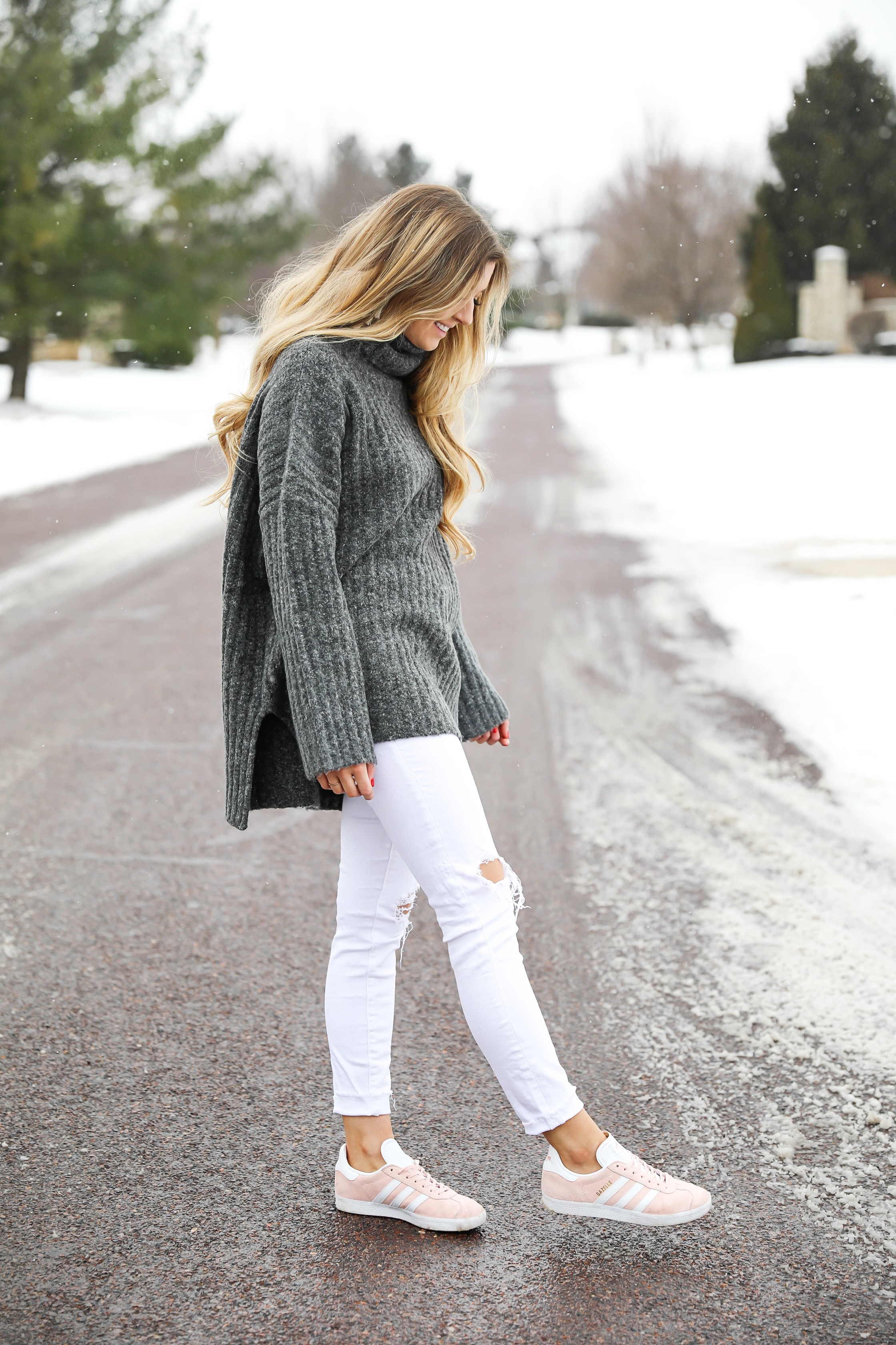 Grey oversized sweater with white jeans and pink sneakers! I paired them with my white earrings and I think it is a perfect outfit to transition into spring! Also a cute Valentine's Day. Details on fashion blog daily dose of charm by lauren lindmark