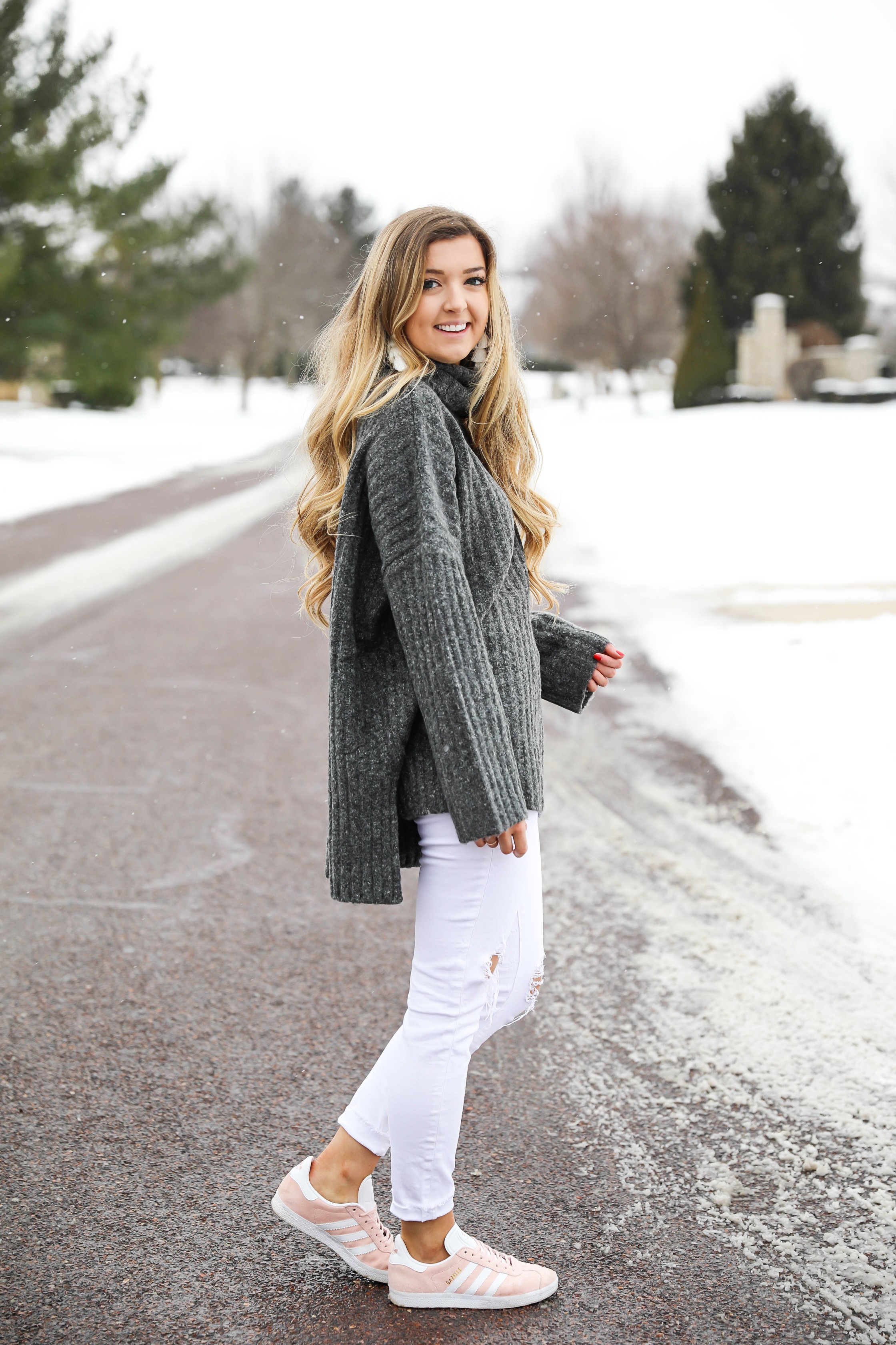 Grey oversized sweater with white jeans and pink sneakers! I paired them with my white earrings and I think it is a perfect outfit to transition into spring! Also a cute Valentine's Day. Details on fashion blog daily dose of charm by lauren lindmark