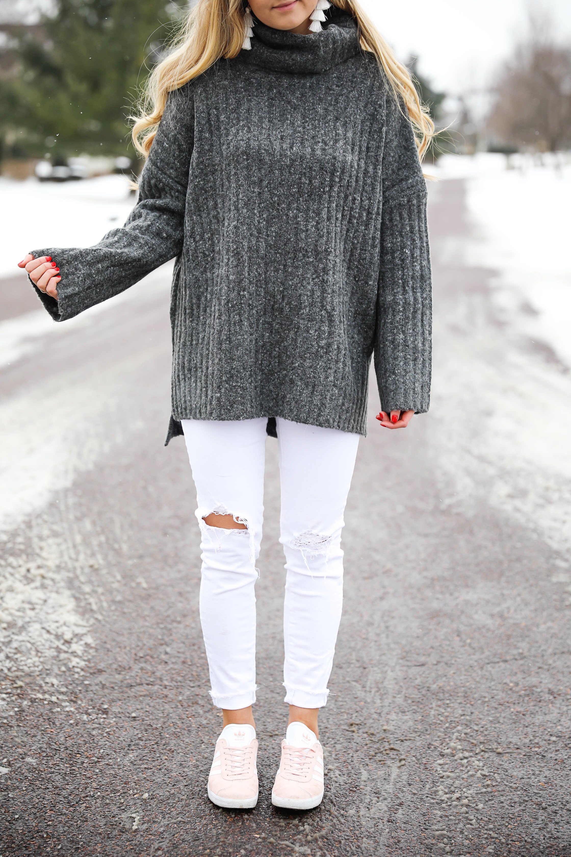 Grey oversized sweater with white jeans and pink sneakers! I paired them with my white earrings and I think it is a perfect outfit to transition into spring! Also a cute Valentine's Day. Details on fashion blog daily dose of charm by lauren lindmark