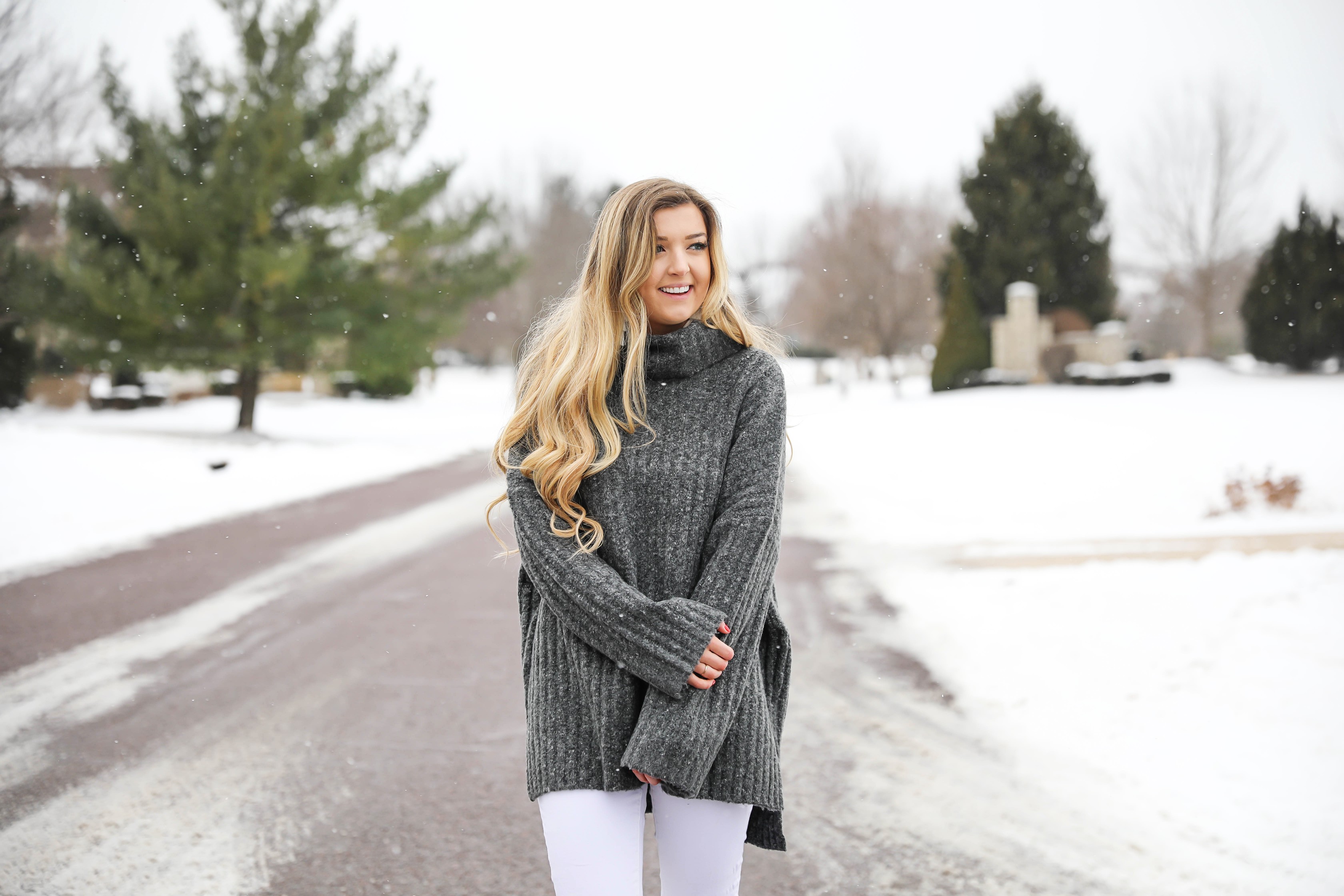 Grey oversized sweater with white jeans and pink sneakers! I paired them with my white earrings and I think it is a perfect outfit to transition into spring! Also a cute Valentine's Day. Details on fashion blog daily dose of charm by lauren lindmark