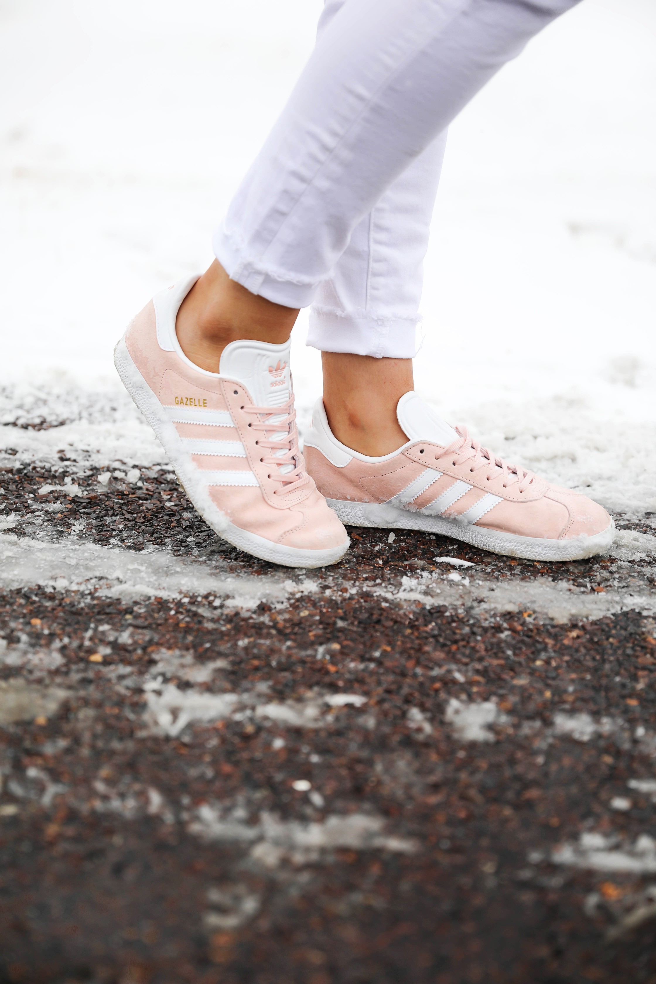 Grey oversized sweater with white jeans and pink sneakers! I paired them with my white earrings and I think it is a perfect outfit to transition into spring! Also a cute Valentine's Day. Details on fashion blog daily dose of charm by lauren lindmark