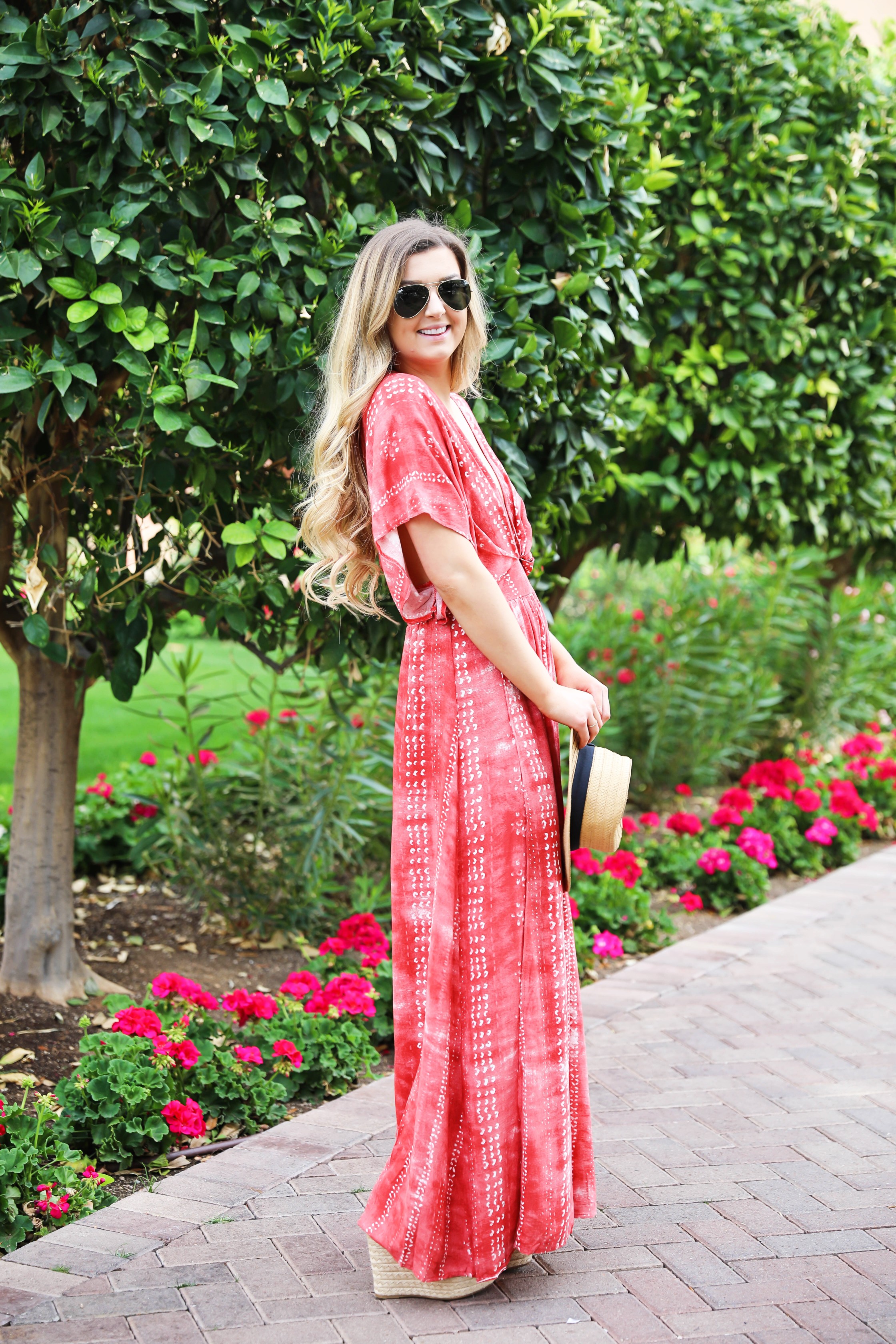 Red tie dye maxi dress from Showpo! Maxi dress with a cute plunging neckline paired with astraw hat and Marc fisher wedges! Details on fashion blog daily dose of charm by lauren lindmark spring break outfit ideas